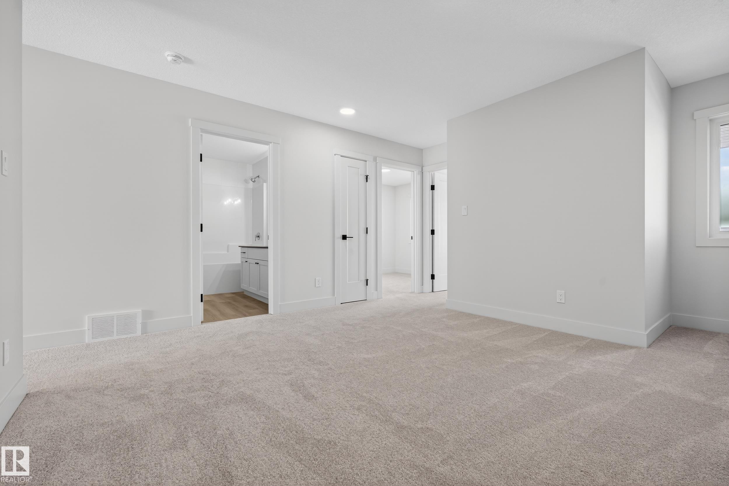 Unfurnished bedroom with light colored carpet and ensuite bathroom - 22 Grayson Green, Stony Plain, AB - Indoor Photo Showing Other Room