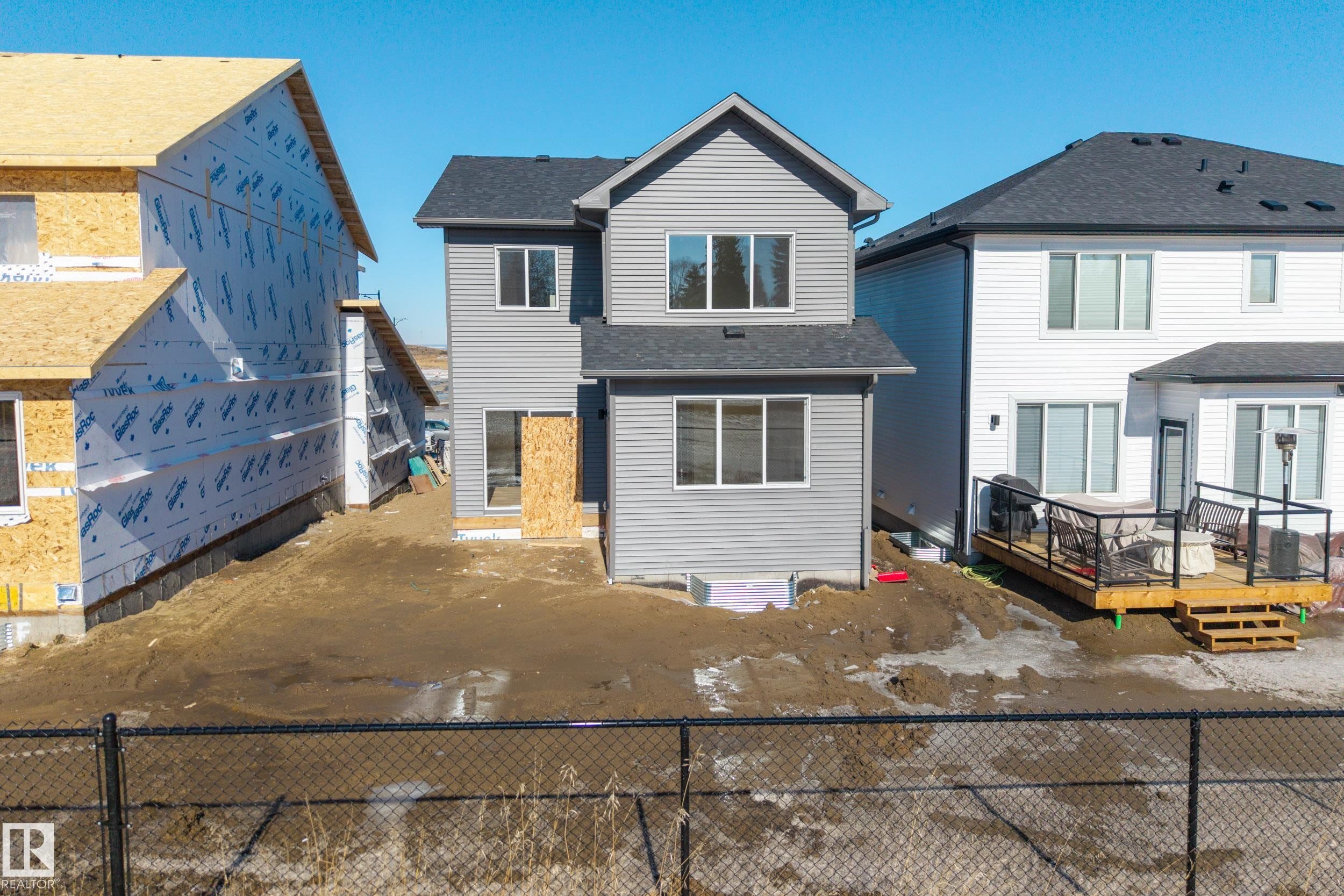 View of front of home with a wooden deck and roof with shingles - 22 Grayson Green, Stony Plain, AB - Outdoor