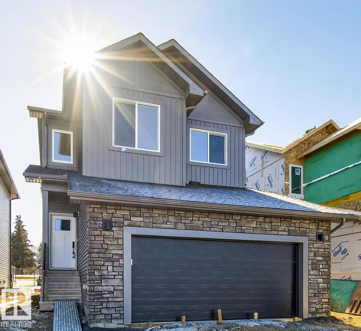 View of front of house with stone siding, board and batten siding, and a garage - 22 Grayson Green, Stony Plain, AB - Outdoor