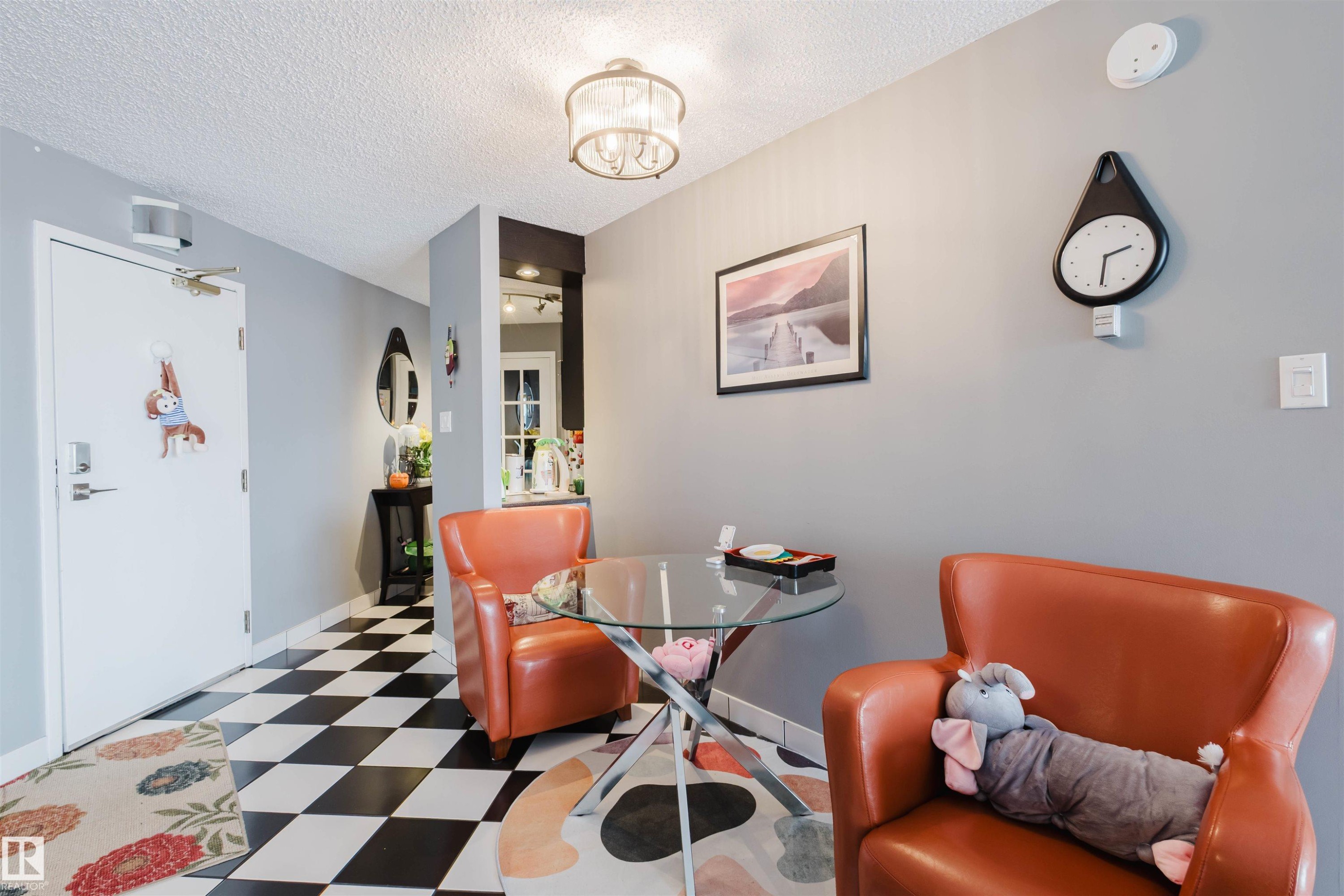 Dining area with tile patterned floors and a textured ceiling - 1803 10149 Saskatchewan Drive, Edmonton, AB - Indoor