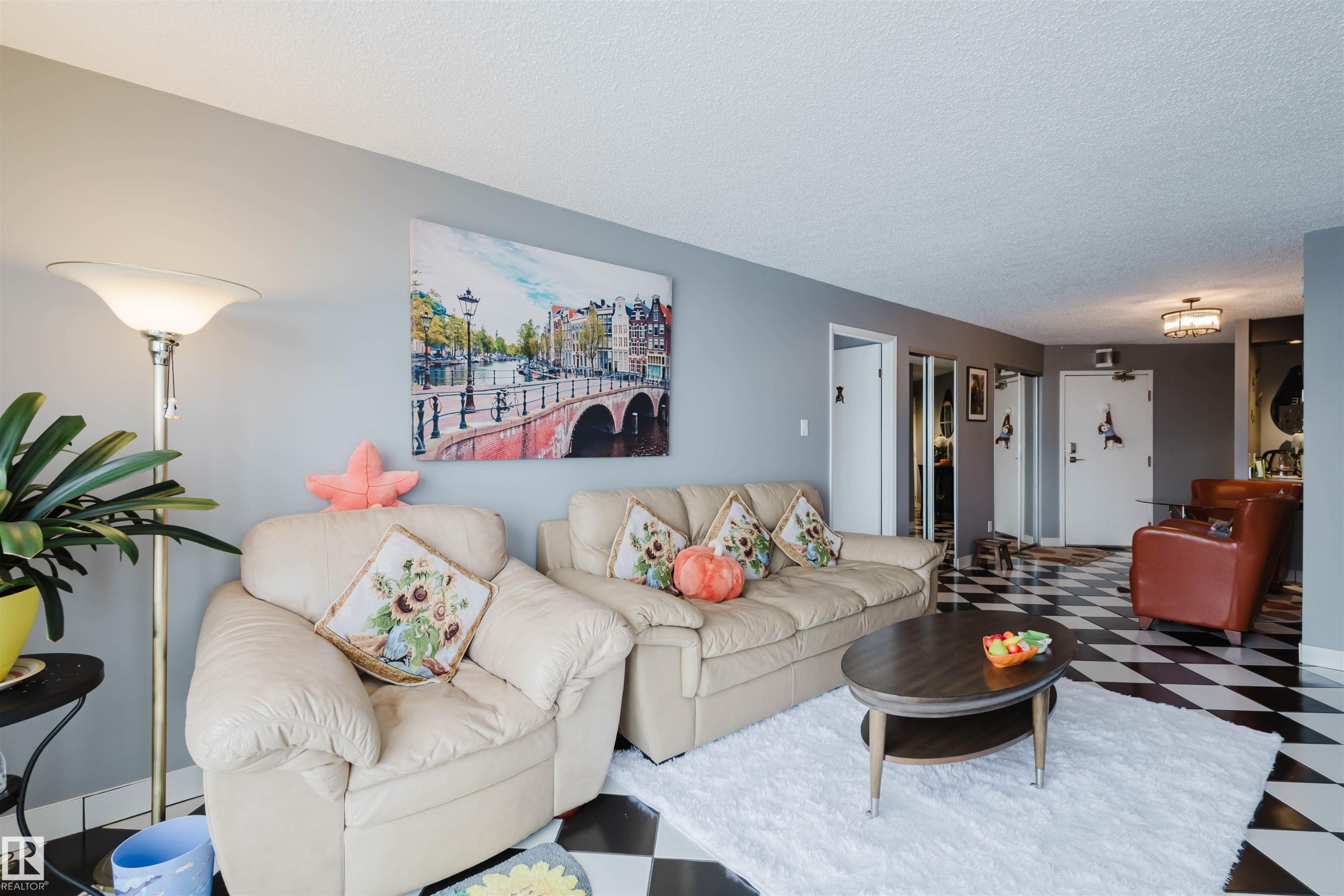 Living room featuring tile patterned floors and a textured ceiling - 1803 10149 Saskatchewan Drive, Edmonton, AB - Indoor Photo Showing Living Room