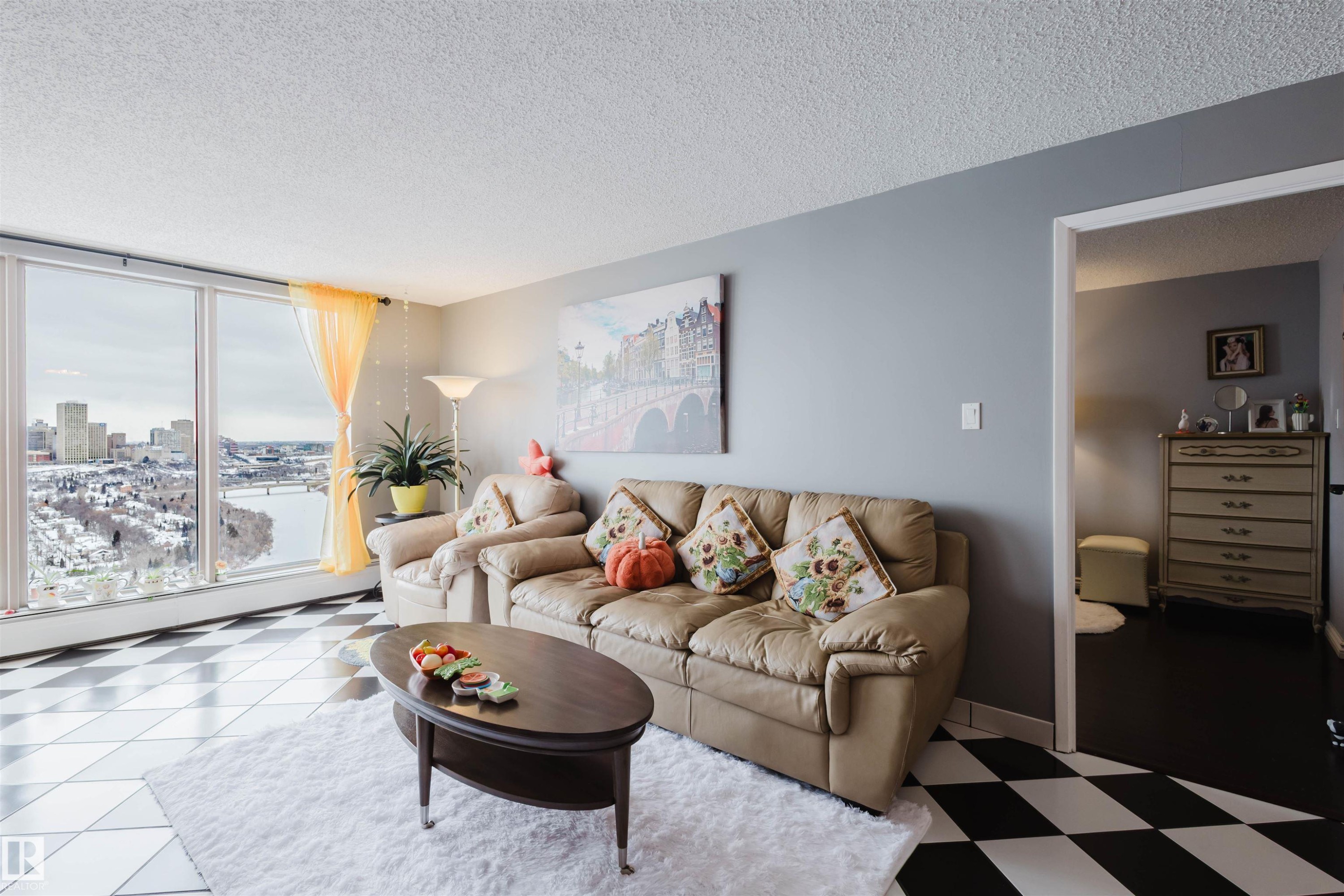 Living area with a textured ceiling and light flooring - 1803 10149 Saskatchewan Drive, Edmonton, AB - Indoor Photo Showing Living Room