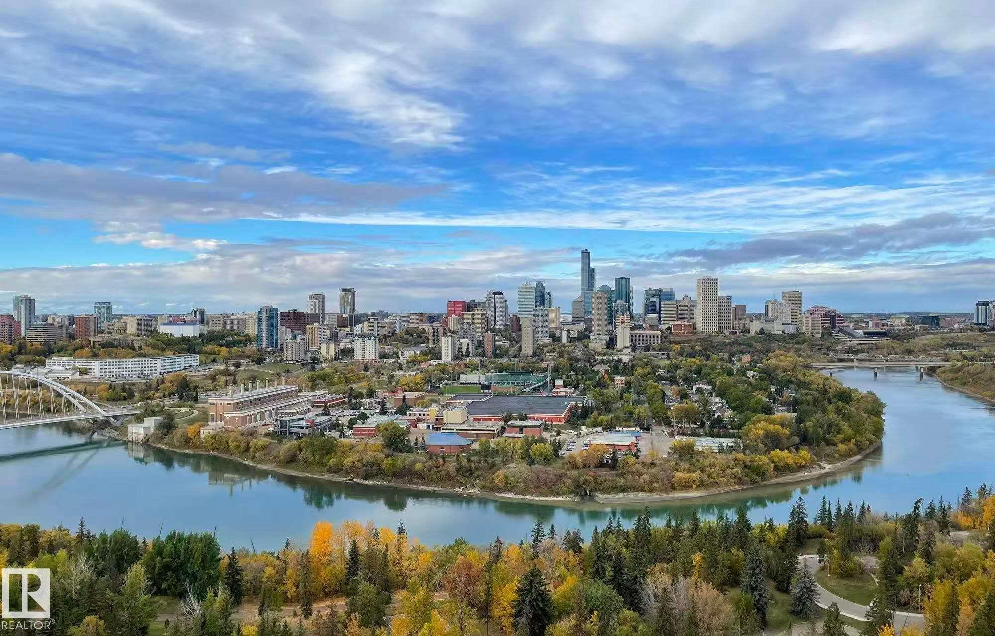 Aerial view of a large body of water, skyline, and a notable bridge - 1803 10149 Saskatchewan Drive, Edmonton, AB - Outdoor With Body Of Water With View
