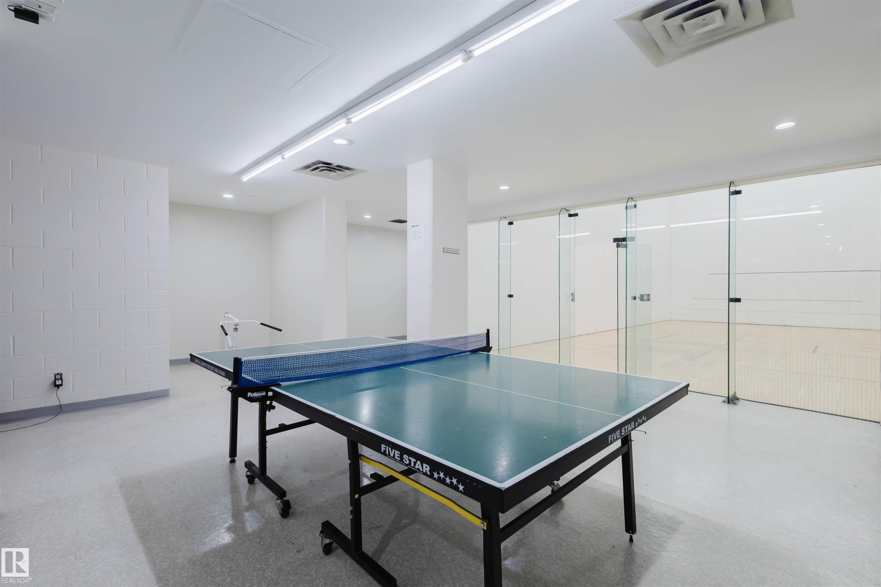 Rec room with finished concrete flooring and recessed lighting - 1803 10149 Saskatchewan Drive, Edmonton, AB - Indoor Photo Showing Other Room