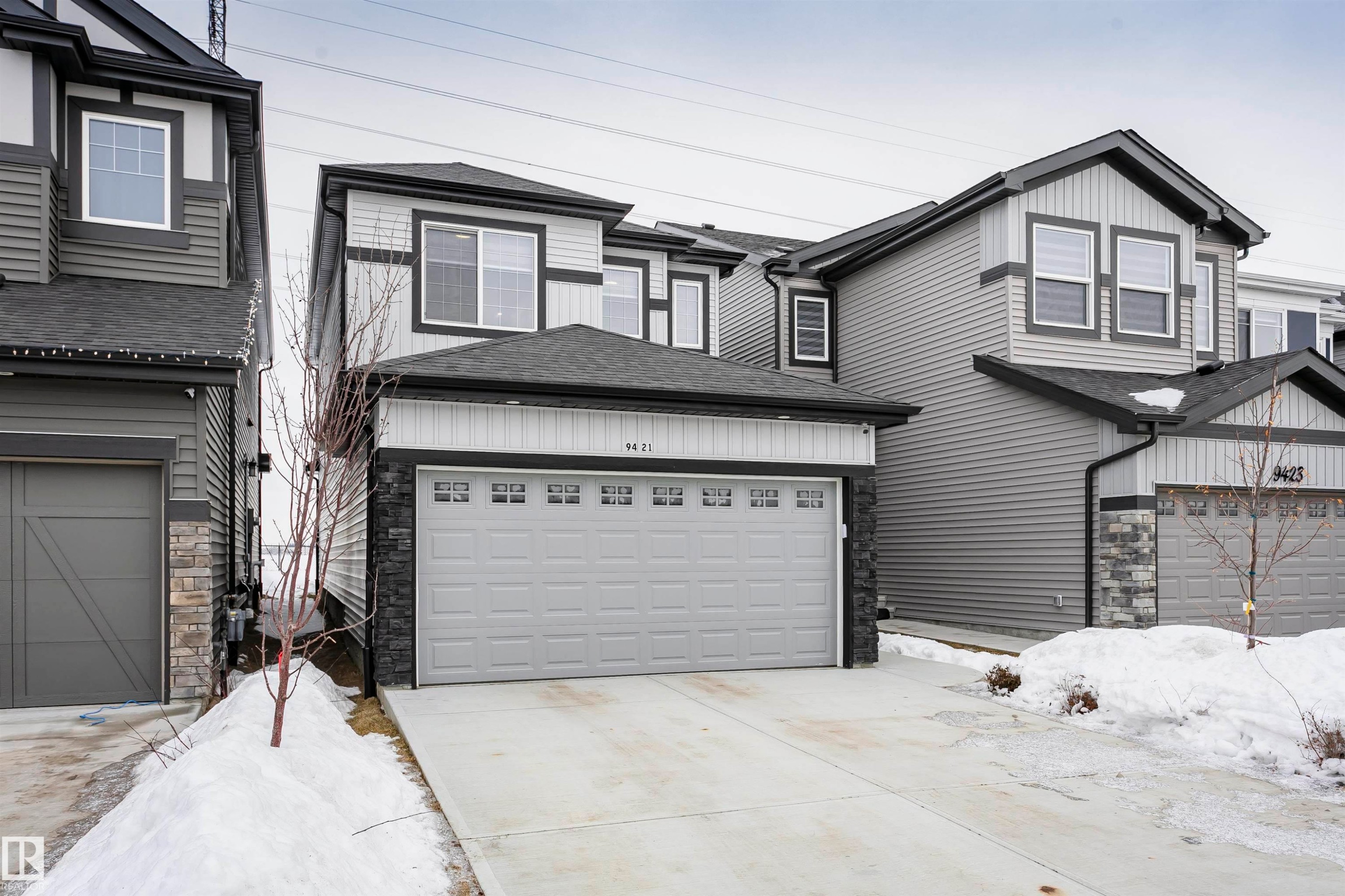 View of front of property with stone siding, roof with shingles, and concrete driveway - 9421 Pear Crescent, Edmonton, AB - Outdoor