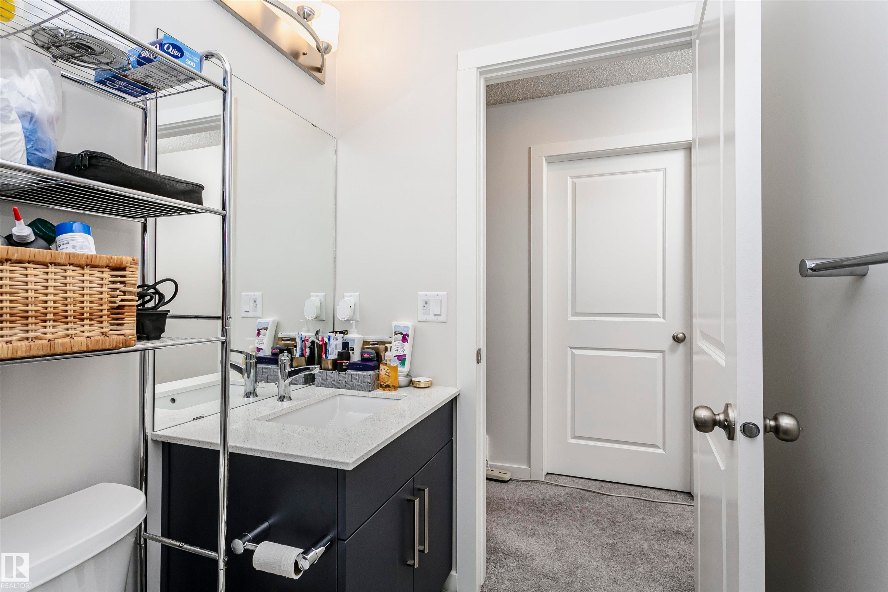 Half bathroom with vanity and light carpet - 9421 Pear Crescent, Edmonton, AB - Indoor Photo Showing Bathroom