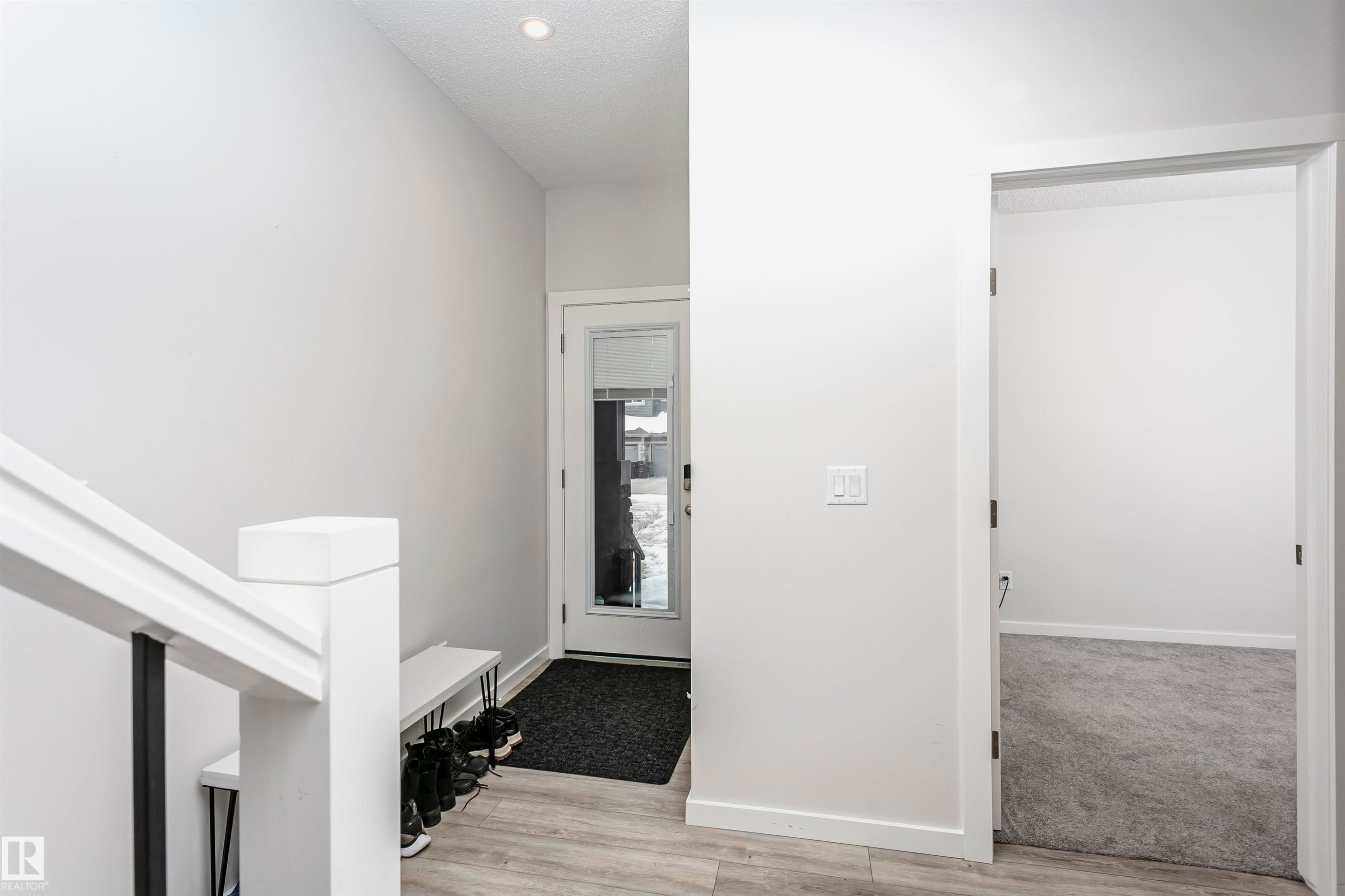 Entryway featuring light wood-type flooring and a textured ceiling - 9421 Pear Crescent, Edmonton, AB - Indoor Photo Showing Other Room