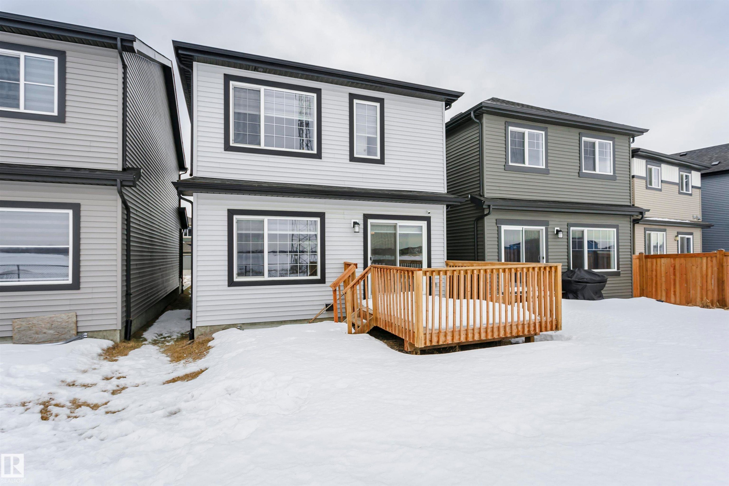 View of front of house with a wooden deck - 9421 Pear Crescent, Edmonton, AB - Outdoor With Exterior