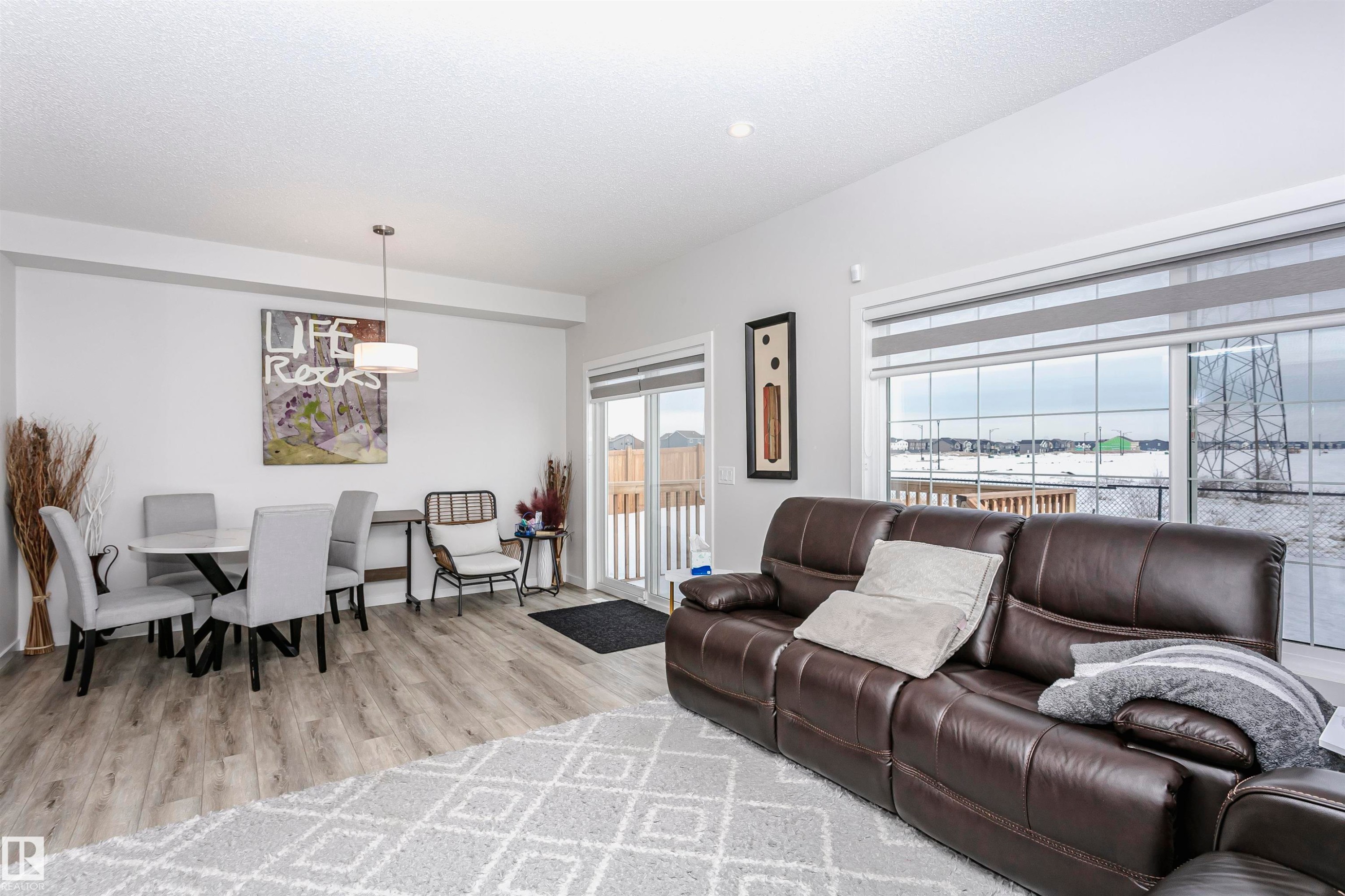 Living area featuring light wood-type flooring and a textured ceiling - 9421 Pear Crescent, Edmonton, AB - Indoor Photo Showing Living Room