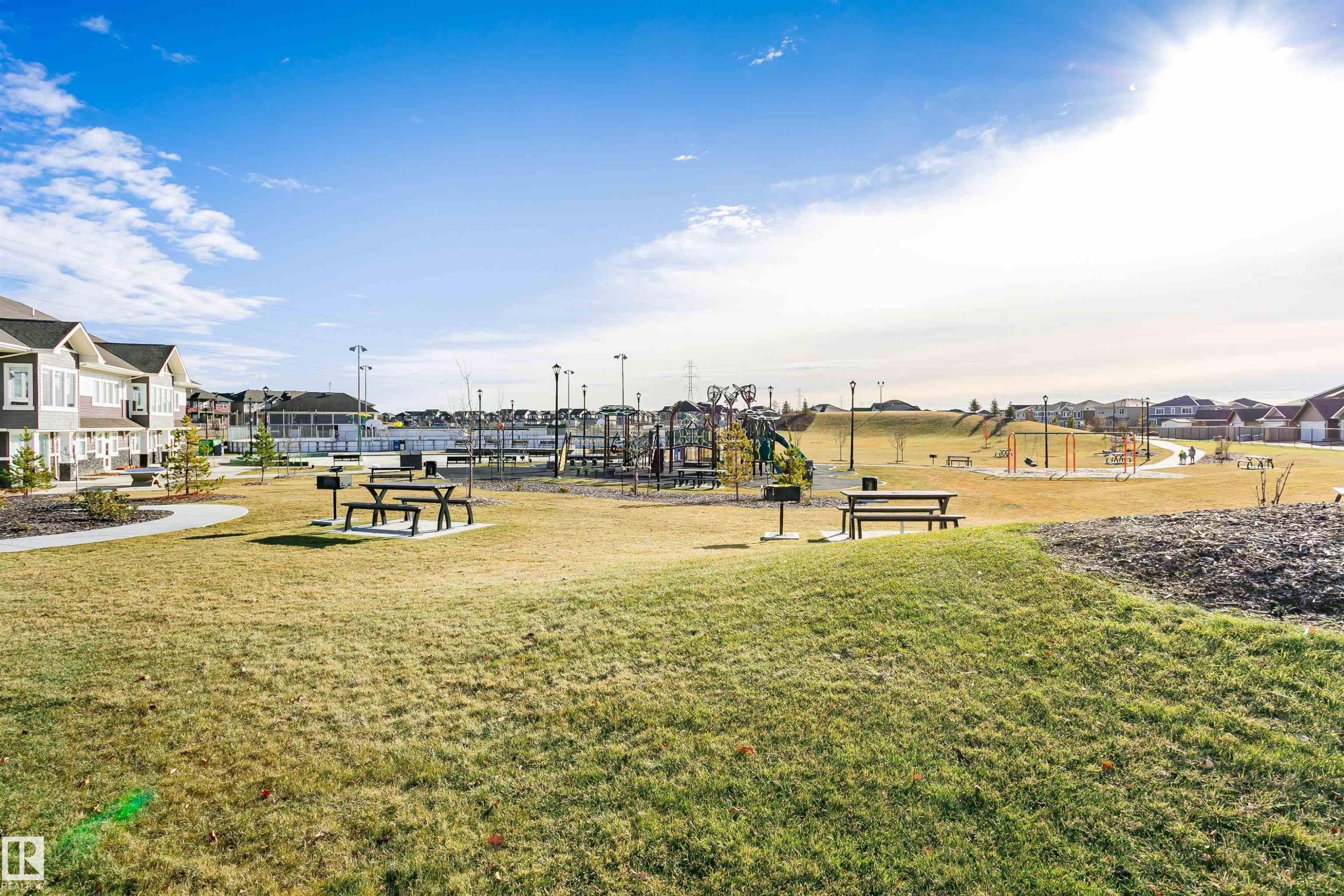 Communal playground featuring a residential view and a lawn - 9421 Pear Crescent, Edmonton, AB - Outdoor With View