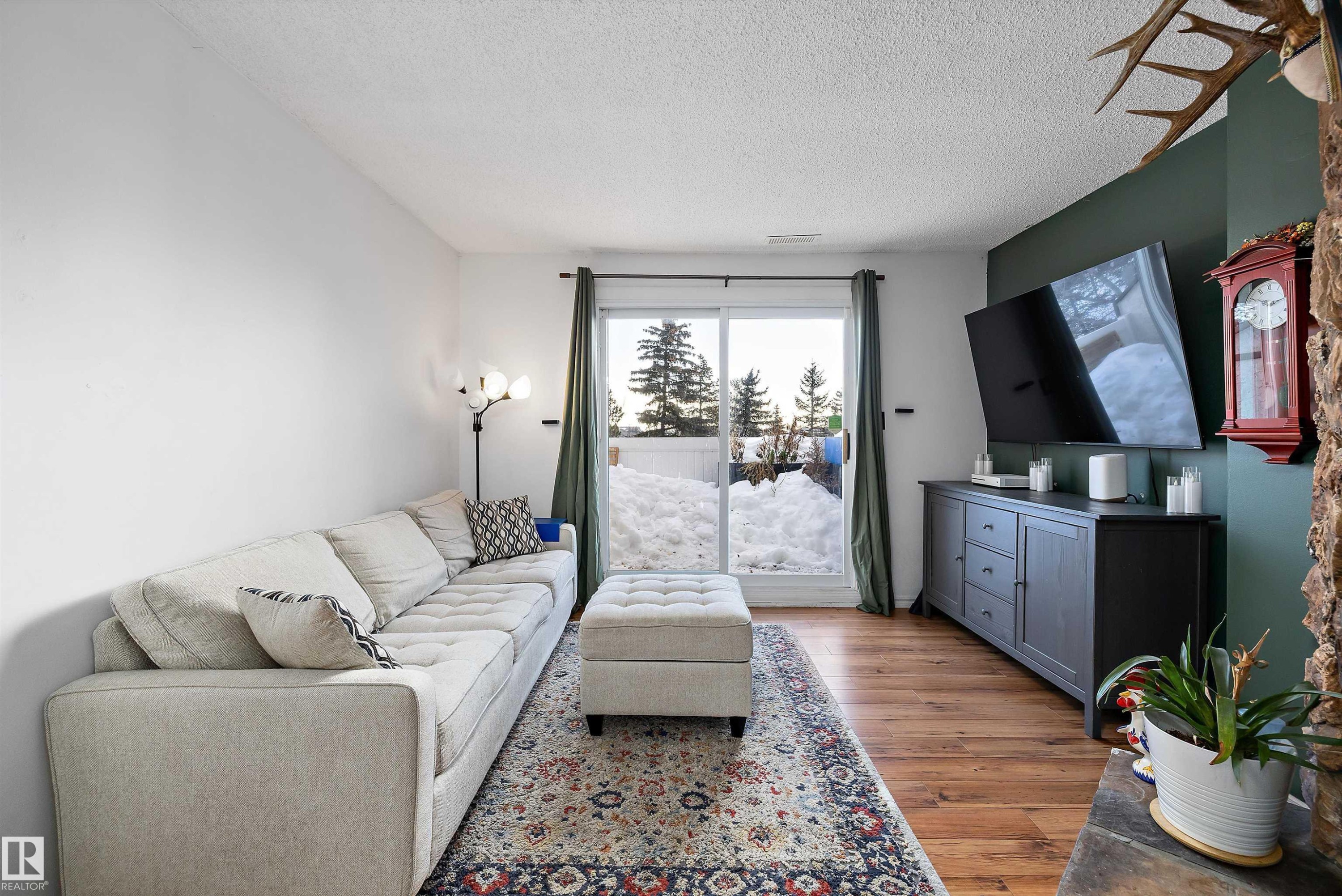 Living room featuring a textured ceiling and light wood finished floors - 139 Lancaster Terrace, Edmonton, AB - Indoor Photo Showing Living Room