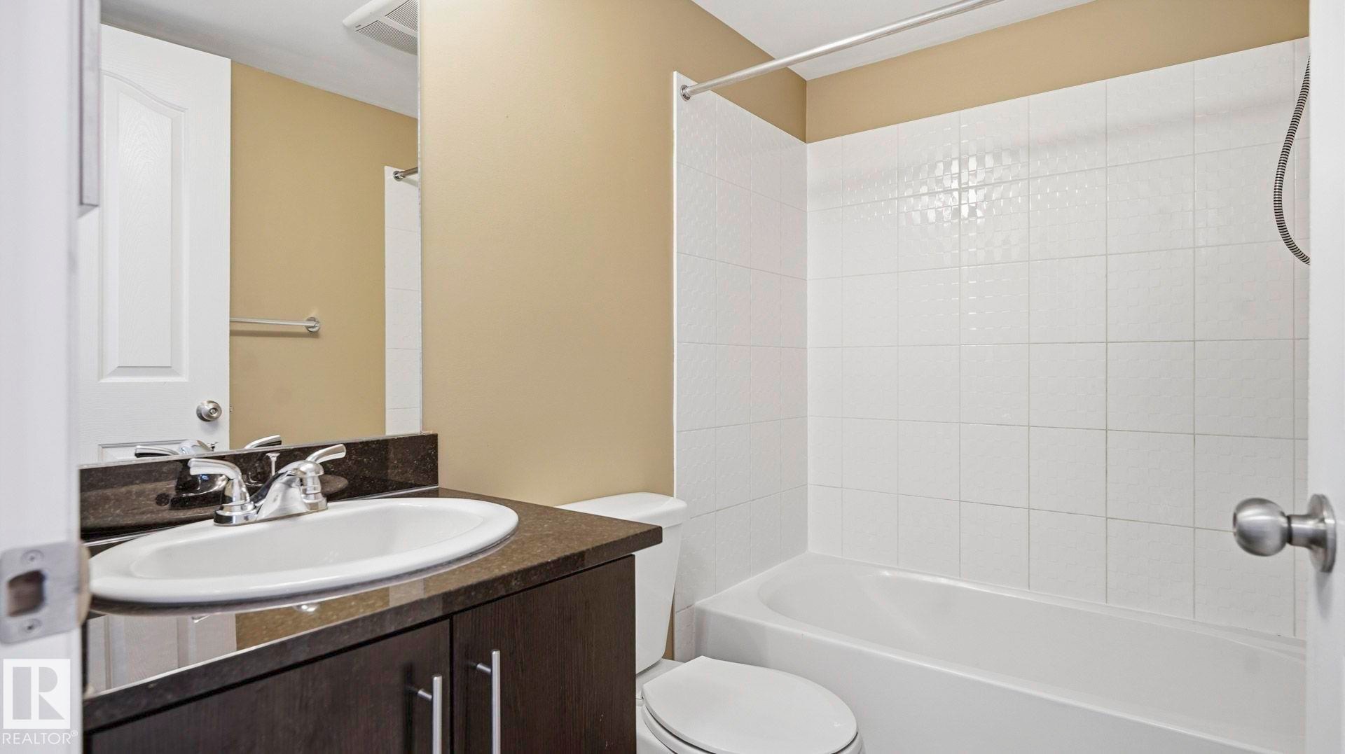 Bathroom featuring vanity and tub / shower combination - 319 274 Mcconachie Drive, Edmonton, AB - Indoor Photo Showing Bathroom