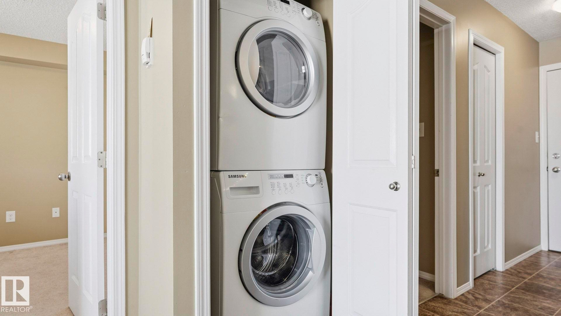 Laundry area featuring a textured ceiling and stacked washer / drying machine - 319 274 Mcconachie Drive, Edmonton, AB - Indoor Photo Showing Laundry Room