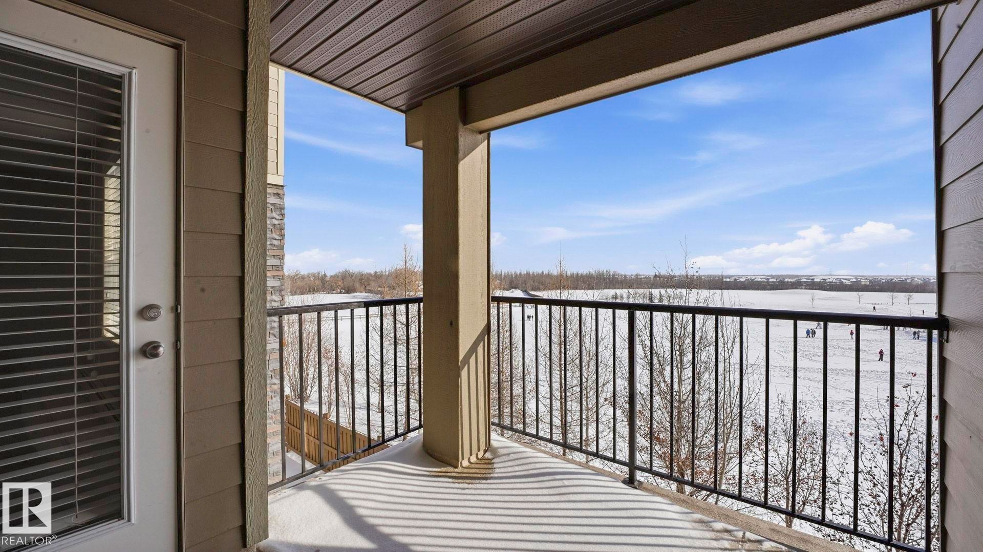 View of snow covered back of property - 319 274 Mcconachie Drive, Edmonton, AB - Outdoor With Balcony With Exterior