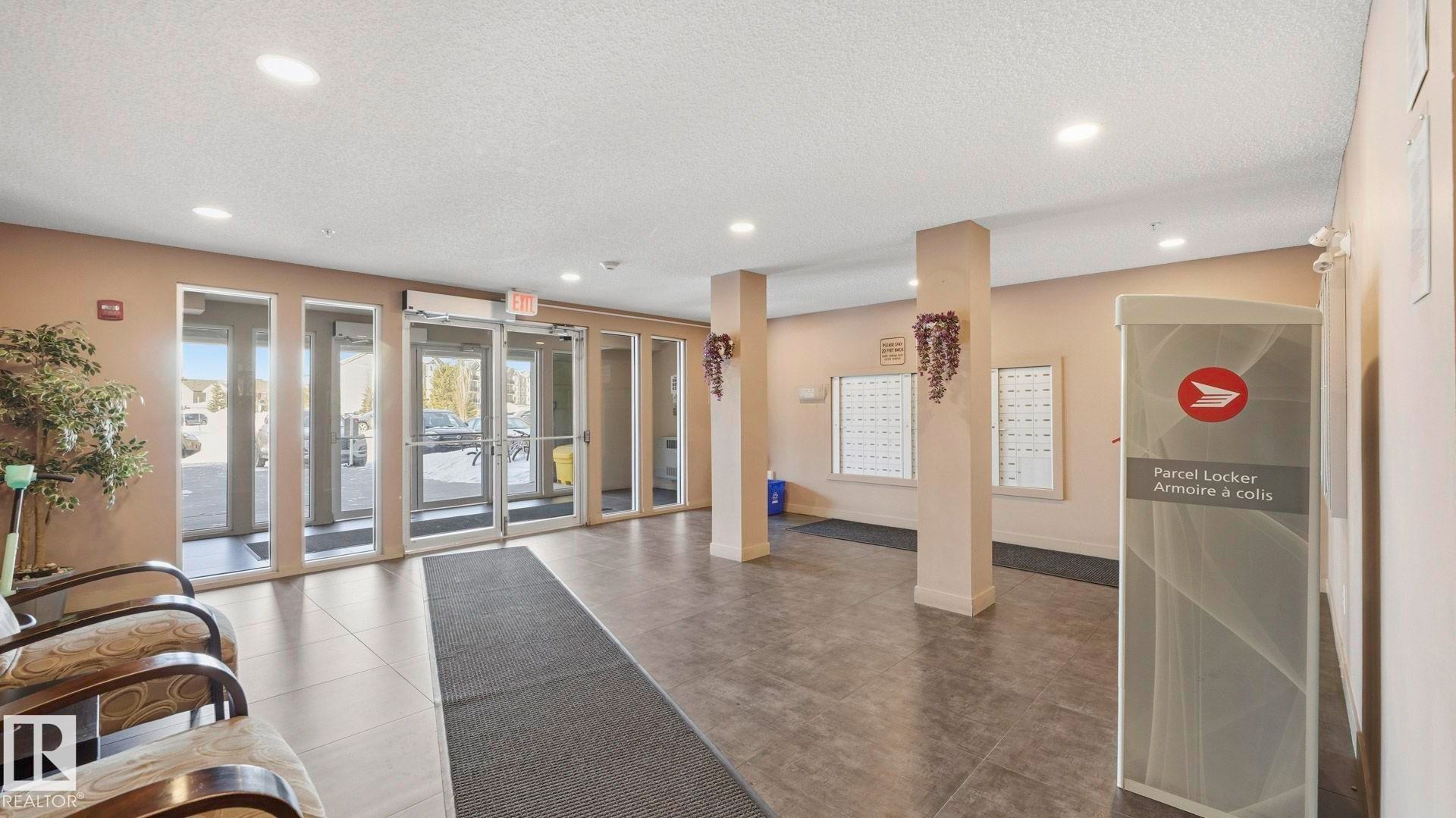 Community lobby with a textured ceiling and recessed lighting - 319 274 Mcconachie Drive, Edmonton, AB - Indoor Photo Showing Other Room