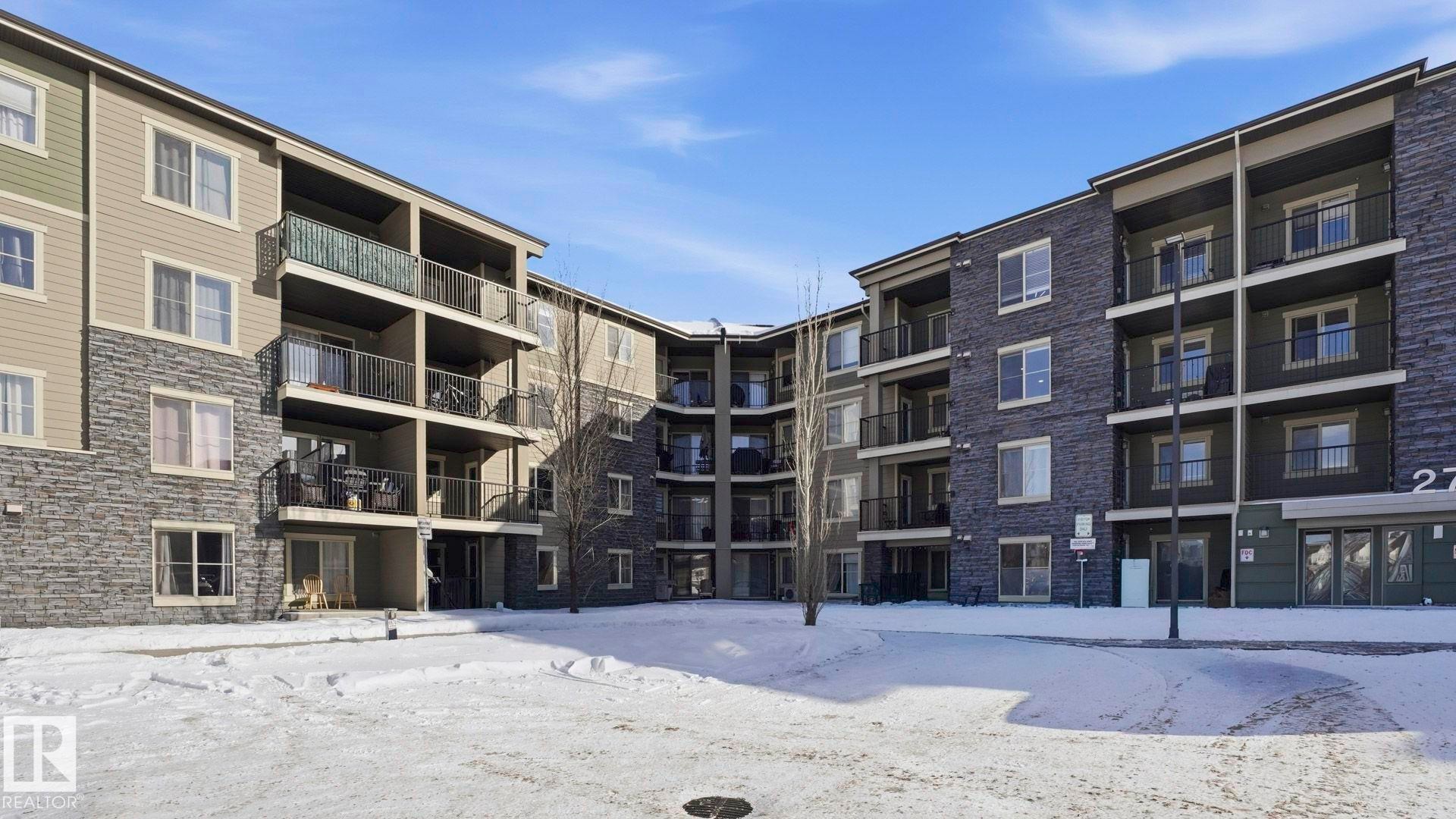 Snow covered building with a view of apartment building / complex - 319 274 Mcconachie Drive, Edmonton, AB - Outdoor With Balcony With Facade