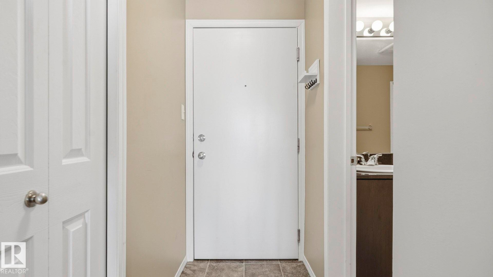 Doorway to outside featuring baseboards and a sink - 319 274 Mcconachie Drive, Edmonton, AB - Indoor Photo Showing Other Room
