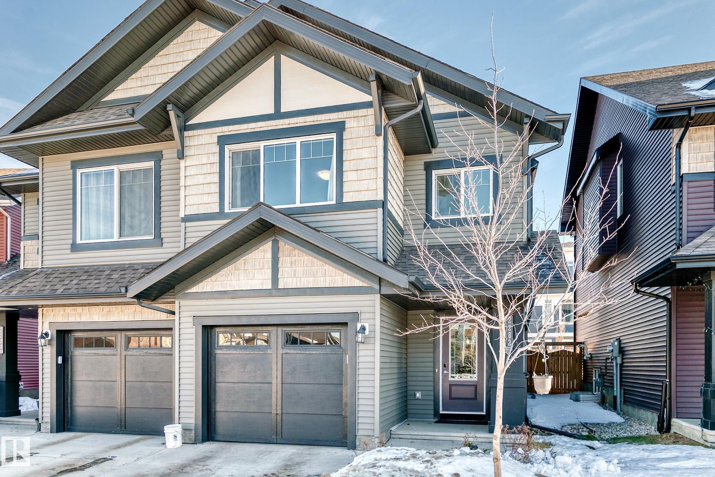 Craftsman-style home featuring a garage, a shingled roof, and driveway - 2282 Chokecherry Close, Edmonton, AB - Outdoor