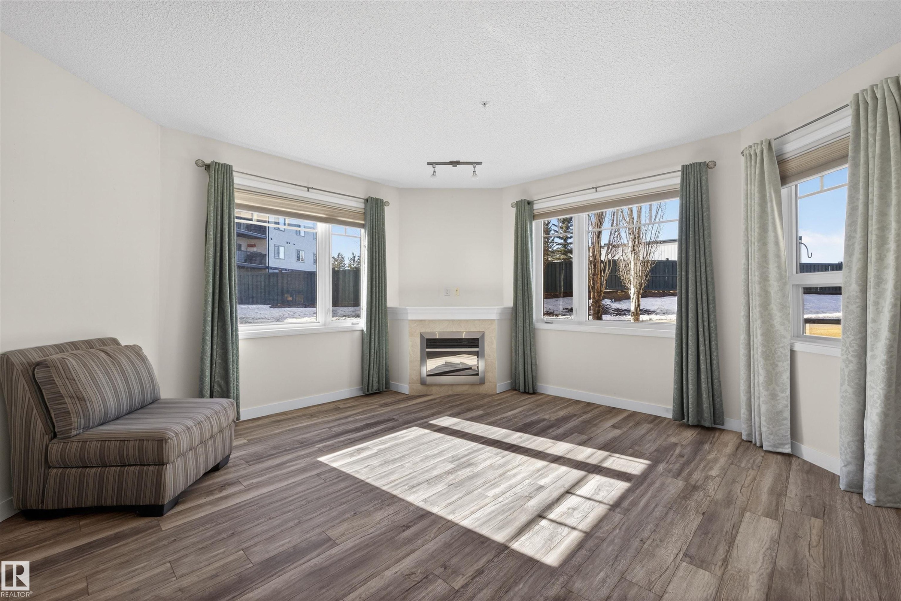 103 2035 Grantham Crest, Edmonton, AB - Indoor Photo Showing Living Room With Fireplace