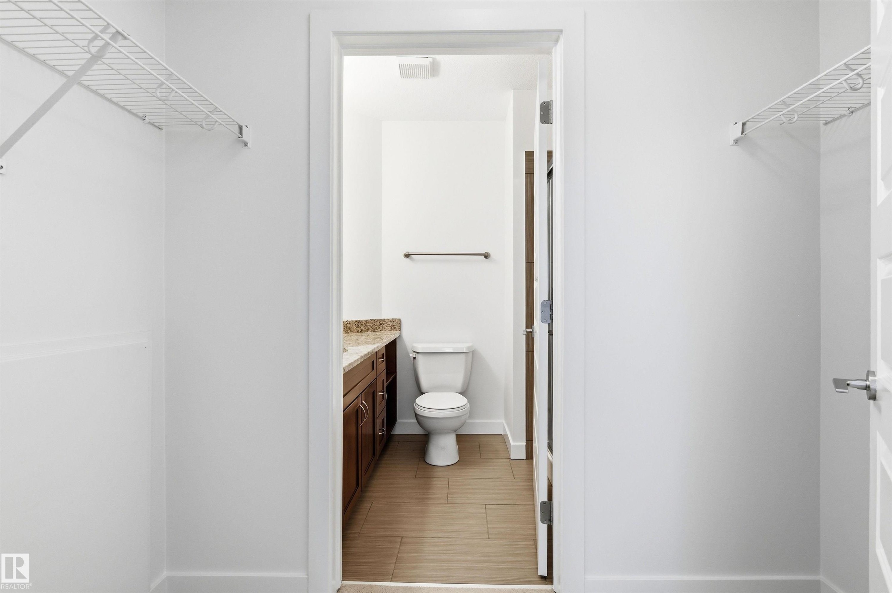 Bathroom featuring vanity and toilet - 106 1238 Windermere Way, Edmonton, AB - Indoor Photo Showing Bathroom