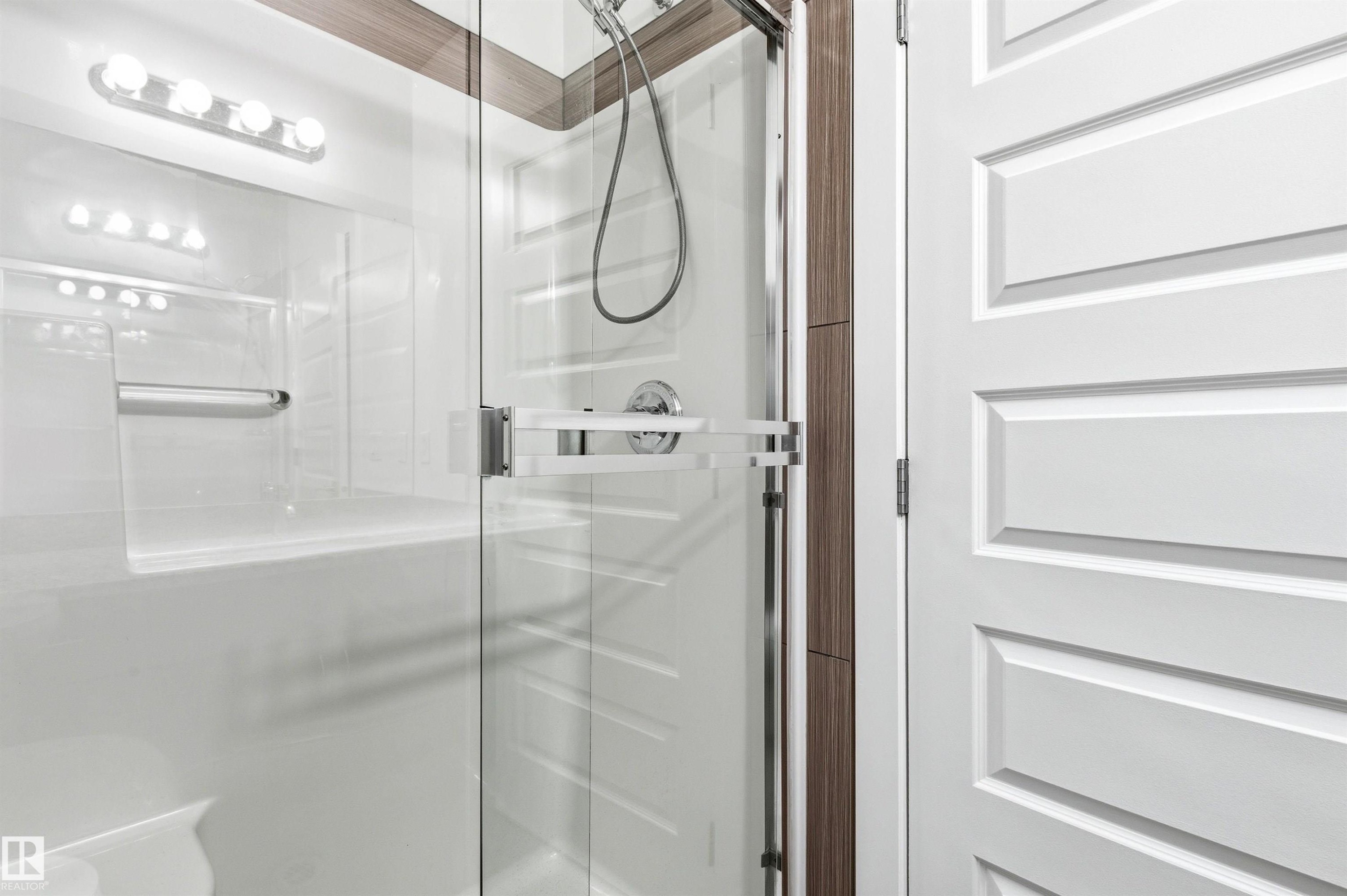 Bathroom featuring a stall shower - 106 1238 Windermere Way, Edmonton, AB - Indoor Photo Showing Bathroom