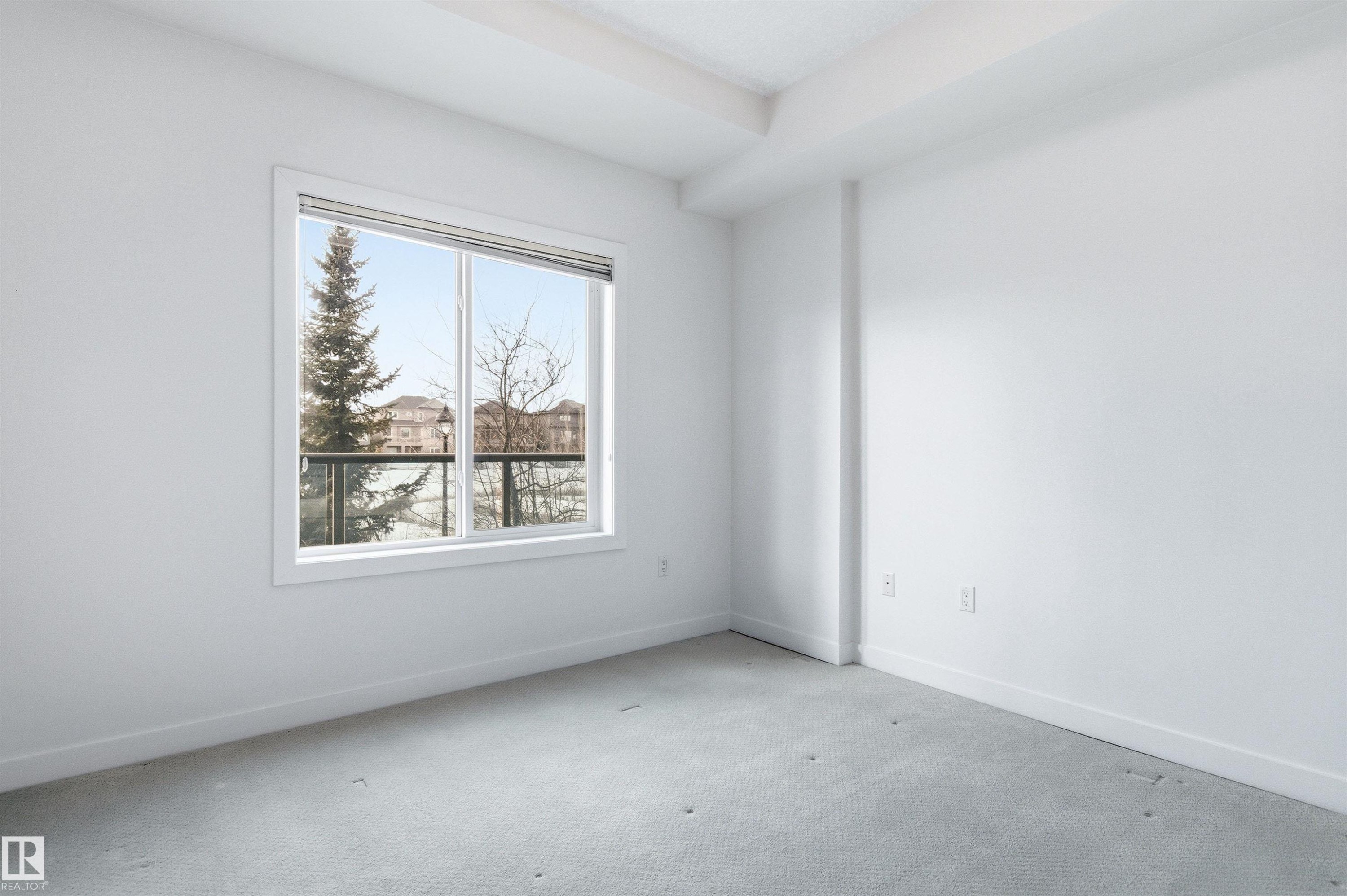 Spare room featuring baseboards and carpet flooring - 106 1238 Windermere Way, Edmonton, AB - Indoor Photo Showing Other Room