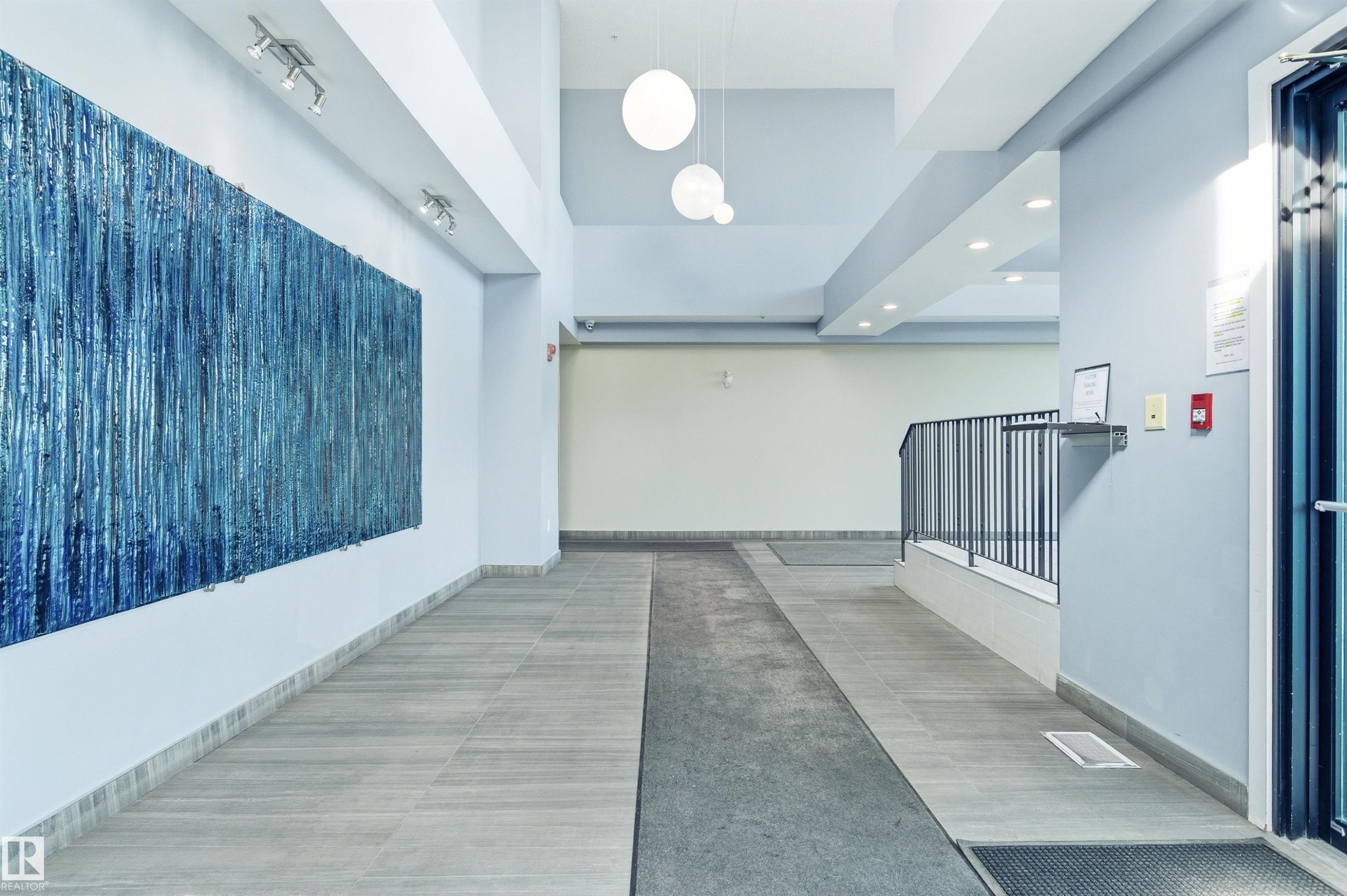Corridor with elevator, recessed lighting, and a high ceiling - 106 1238 Windermere Way, Edmonton, AB - Indoor Photo Showing Other Room