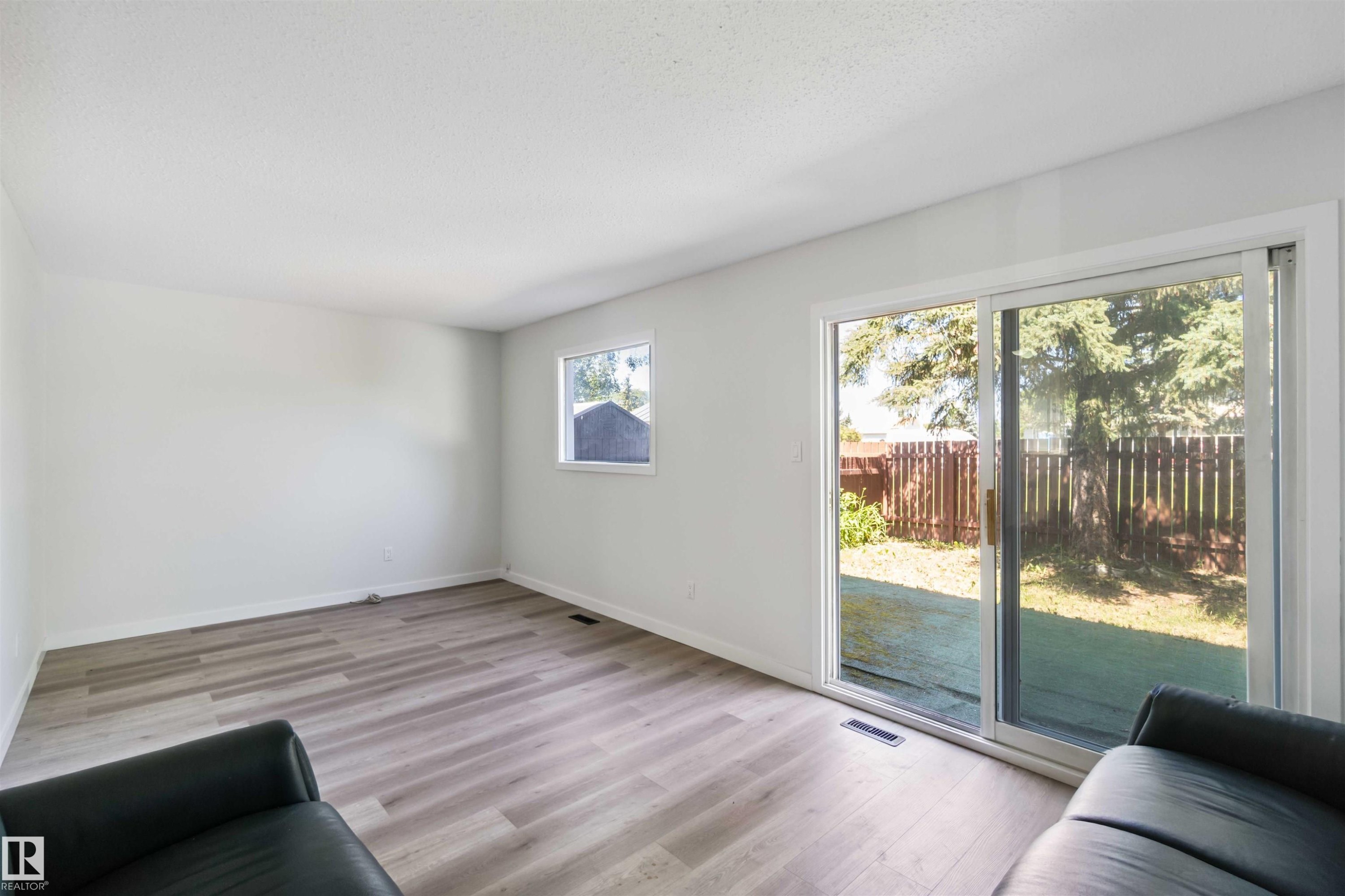 Living area featuring light wood-type flooring and baseboards - 1096 Millbourne Road E, Edmonton, AB - Indoor