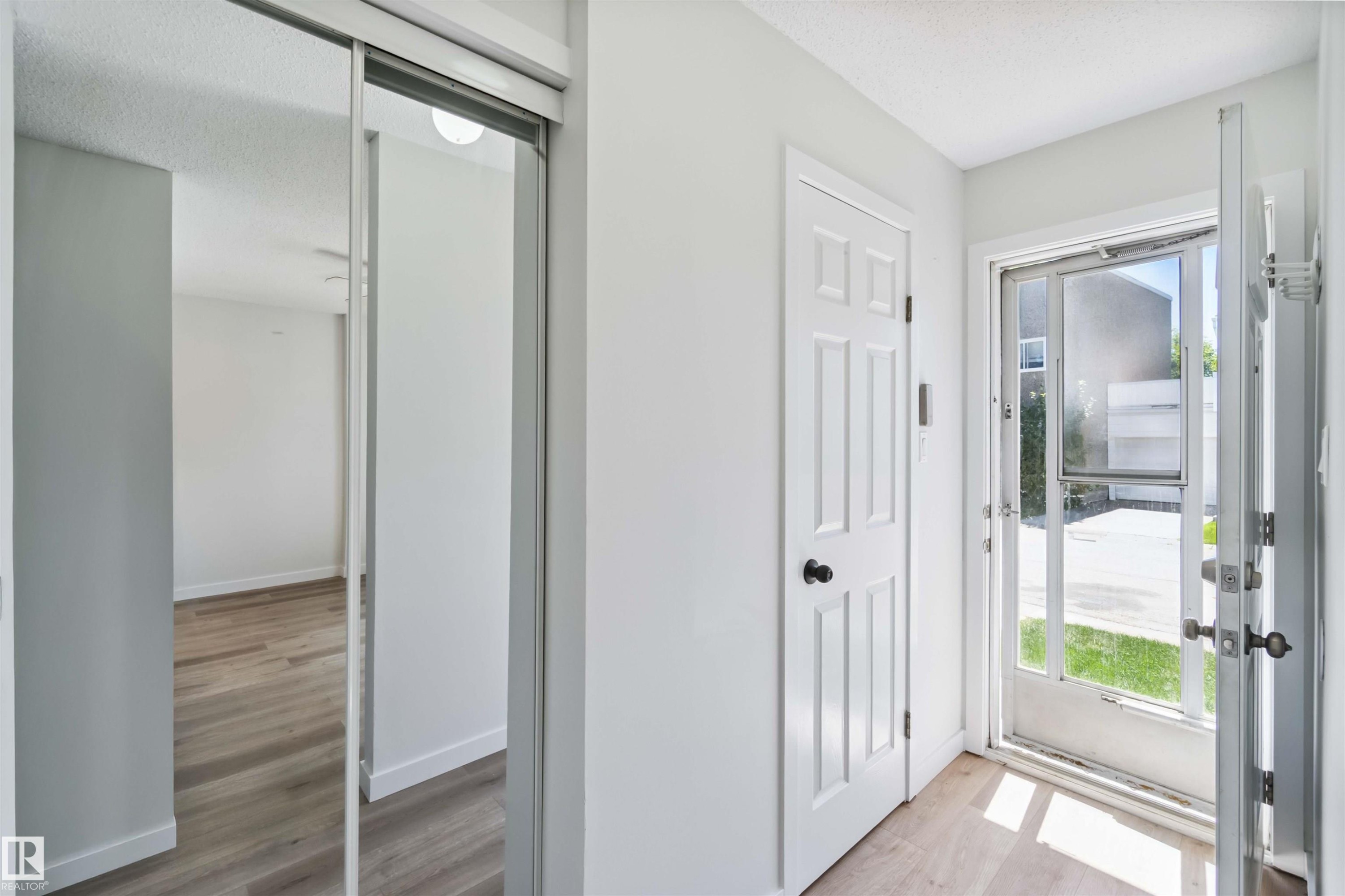 Entrance foyer featuring light wood-type flooring and a textured ceiling - 1096 Millbourne Road E, Edmonton, AB - Indoor Photo Showing Other Room