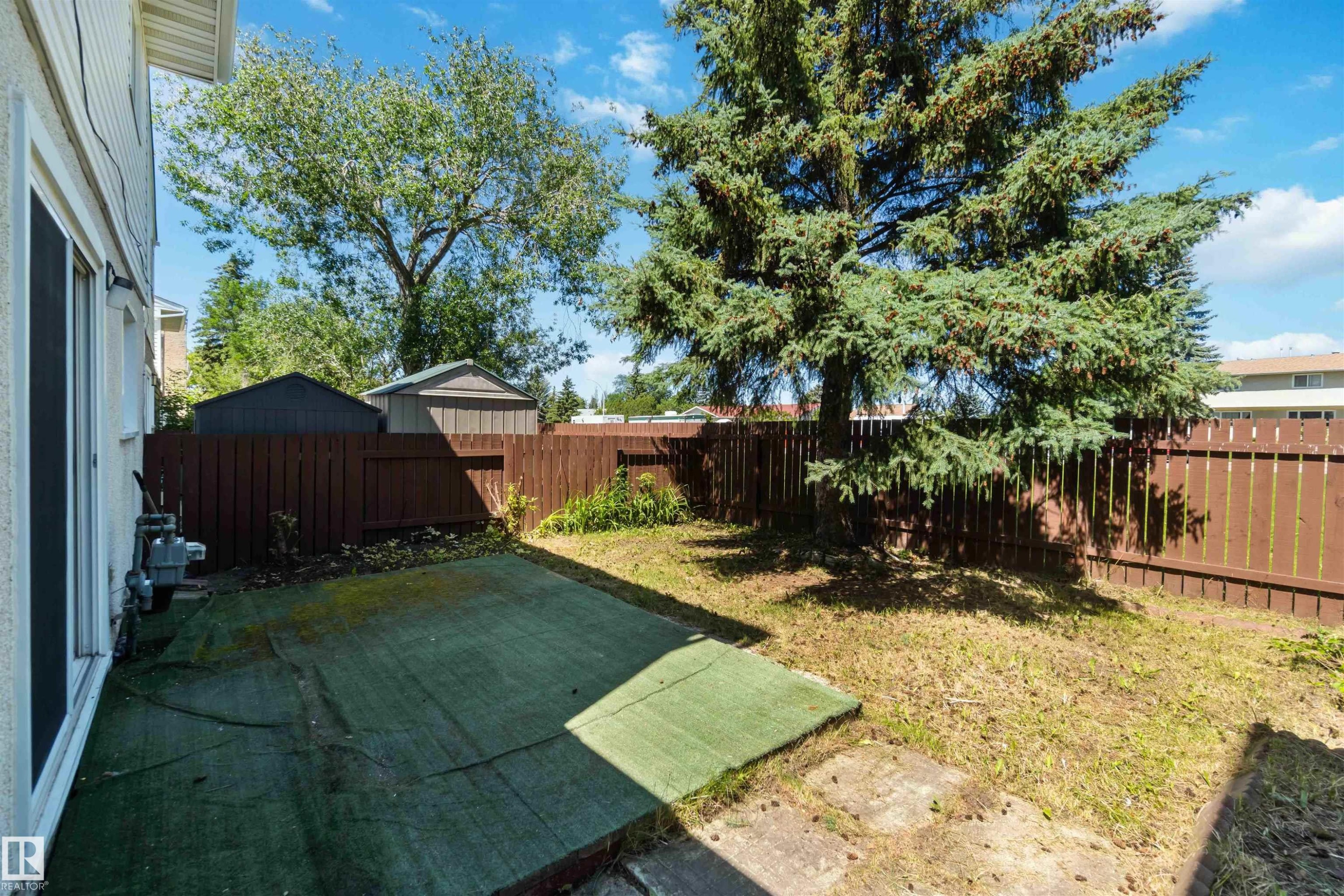 Fenced backyard featuring a patio area - 1096 Millbourne Road E, Edmonton, AB - Outdoor With Backyard