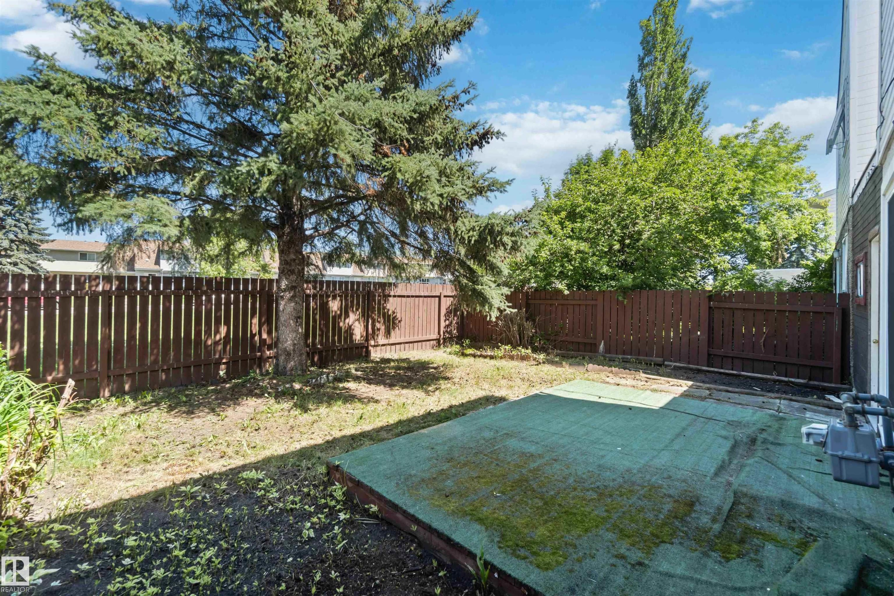 Fenced backyard with a patio area - 1096 Millbourne Road E, Edmonton, AB - Outdoor With Backyard