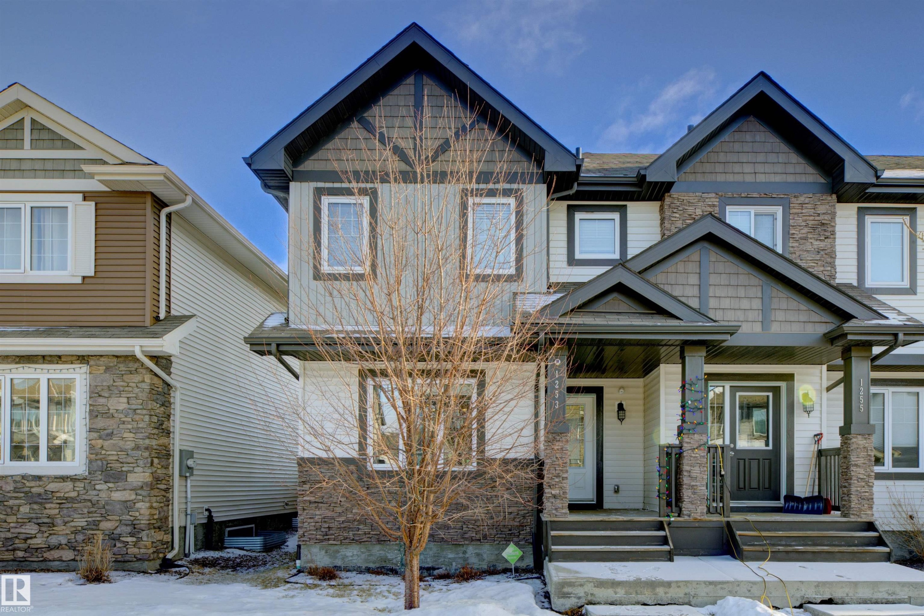 Craftsman-style home featuring covered porch and stone siding - 1253 163 Street, Edmonton, AB - Outdoor With Facade