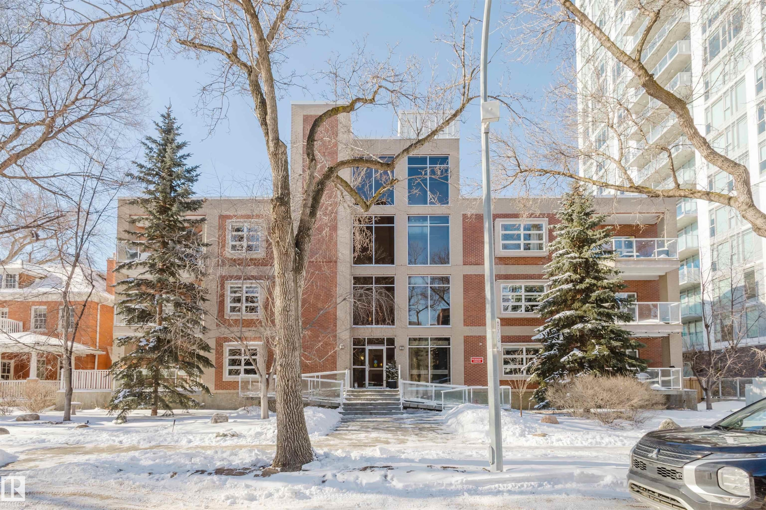 Snow covered building with a view of apartment building / complex - 207 9910 111 Street, Edmonton, AB - Outdoor With Facade