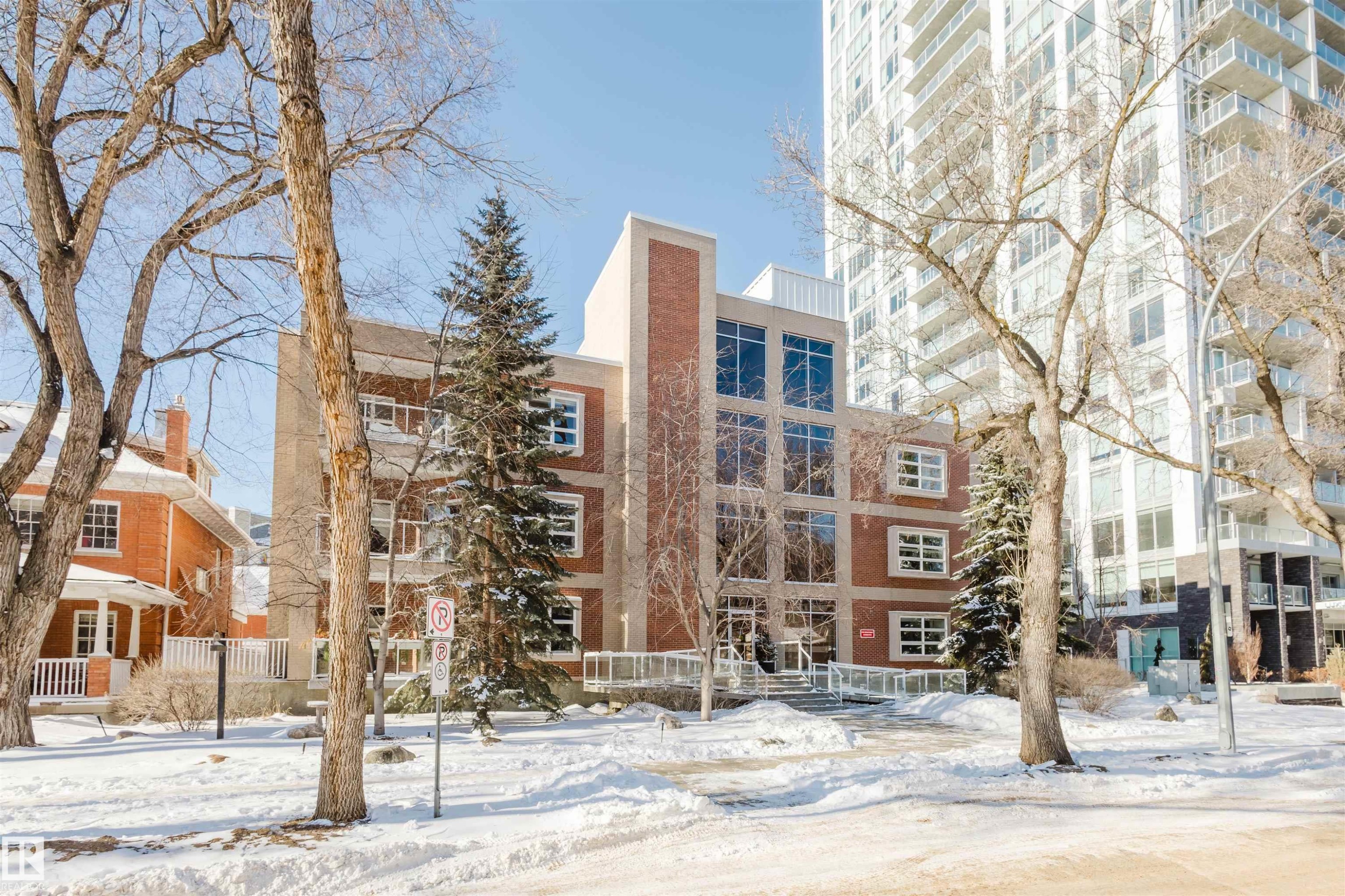 Snow covered property featuring a view of apartment building / complex - 207 9910 111 Street, Edmonton, AB - Outdoor With Facade