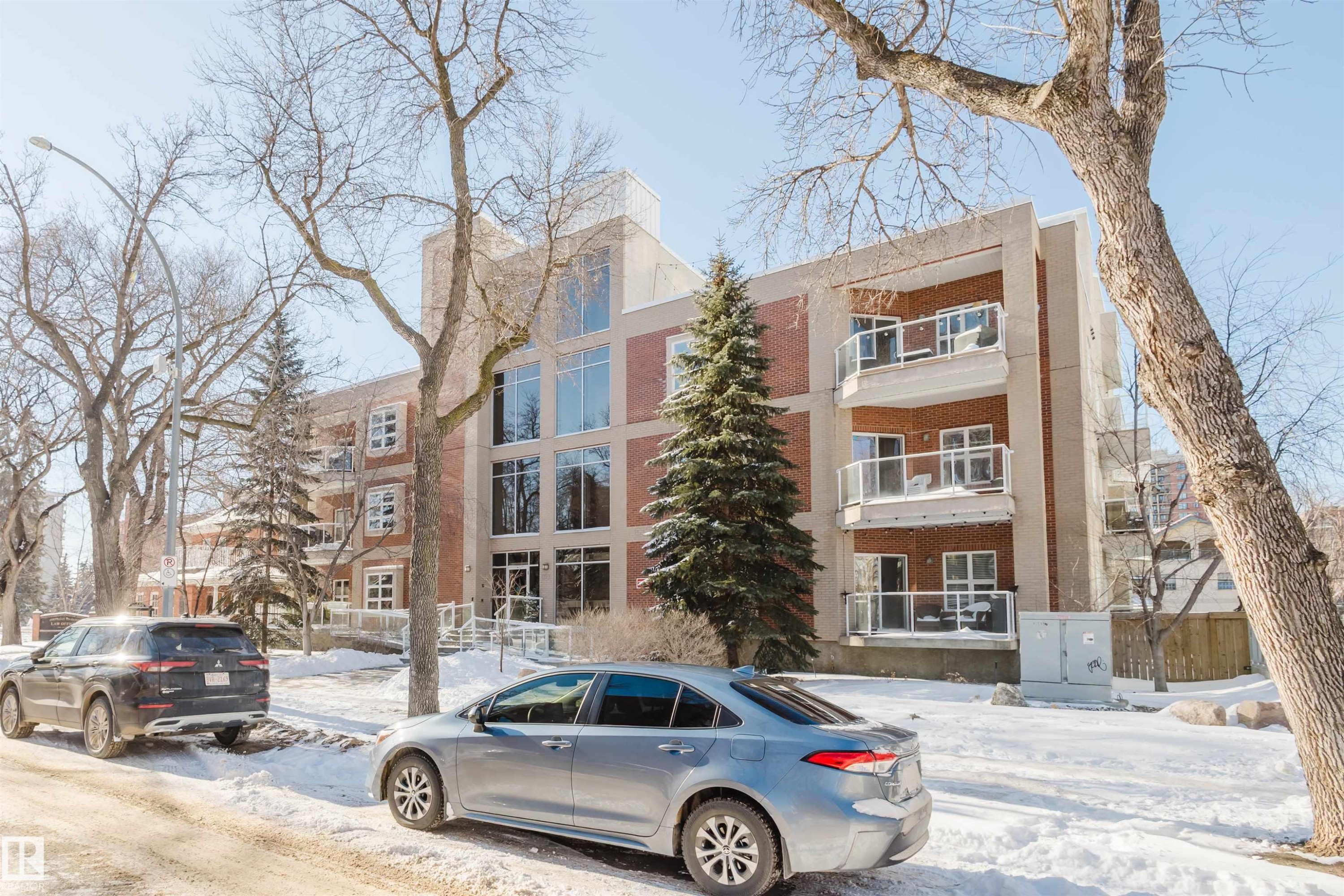 Snow covered property featuring a view of apartment building / complex - 207 9910 111 Street, Edmonton, AB - Outdoor With Facade
