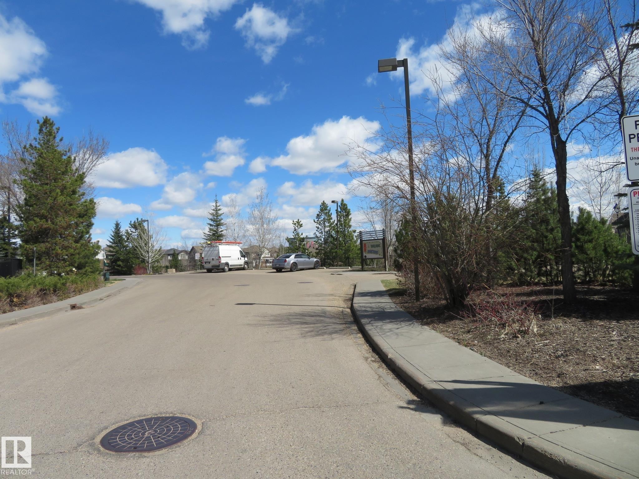 Paved street with concrete sidewalk and established street lighting - 415 2590 Anderson Way, Edmonton, AB - Outdoor With View
