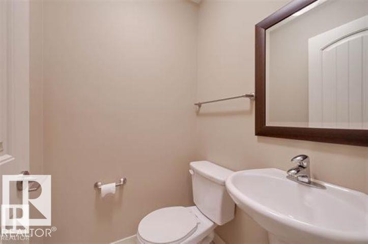 Bathroom featuring toilet and a sink - 1649 Cunningham Way, Edmonton, AB - Indoor Photo Showing Bathroom