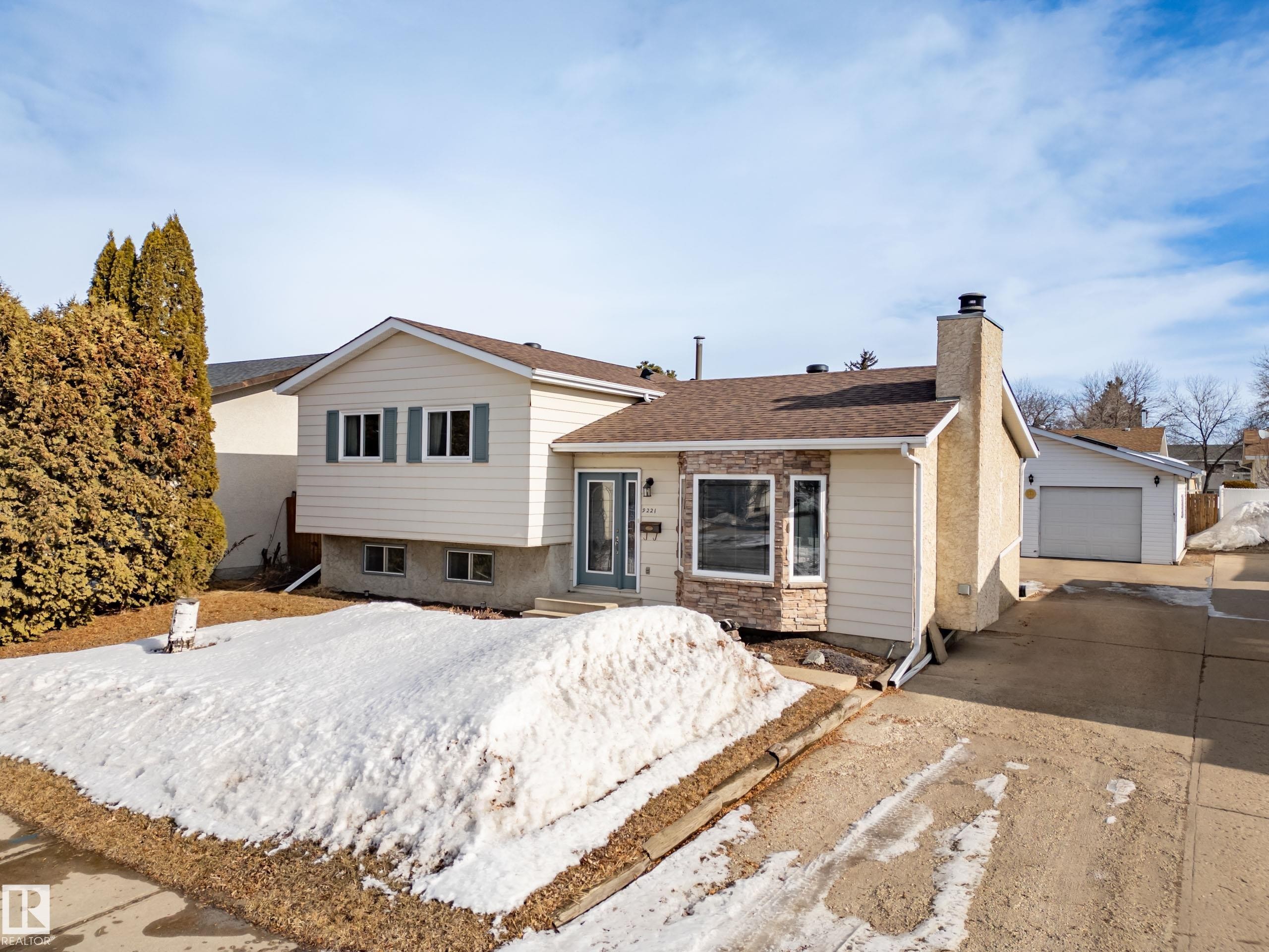 Tri-level home with a chimney, a detached garage, and roof with shingles - 9221 84 Street, Fort Saskatchewan, AB - Outdoor