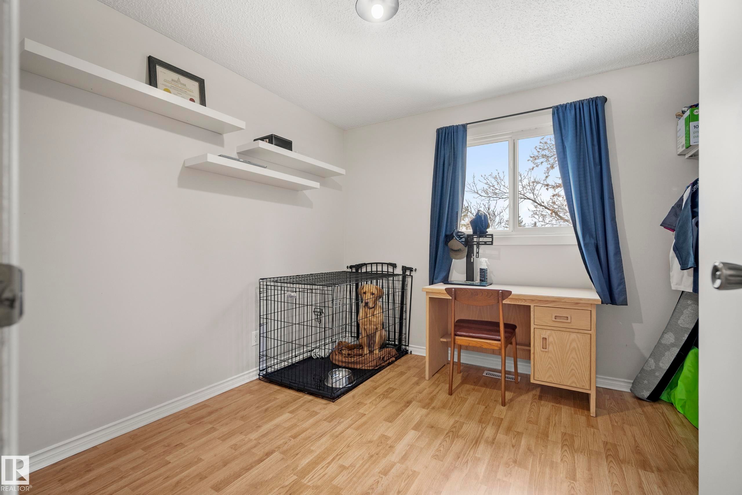 Office area with light wood finished floors and a textured ceiling - 9221 84 Street, Fort Saskatchewan, AB - Indoor Photo Showing Other Room
