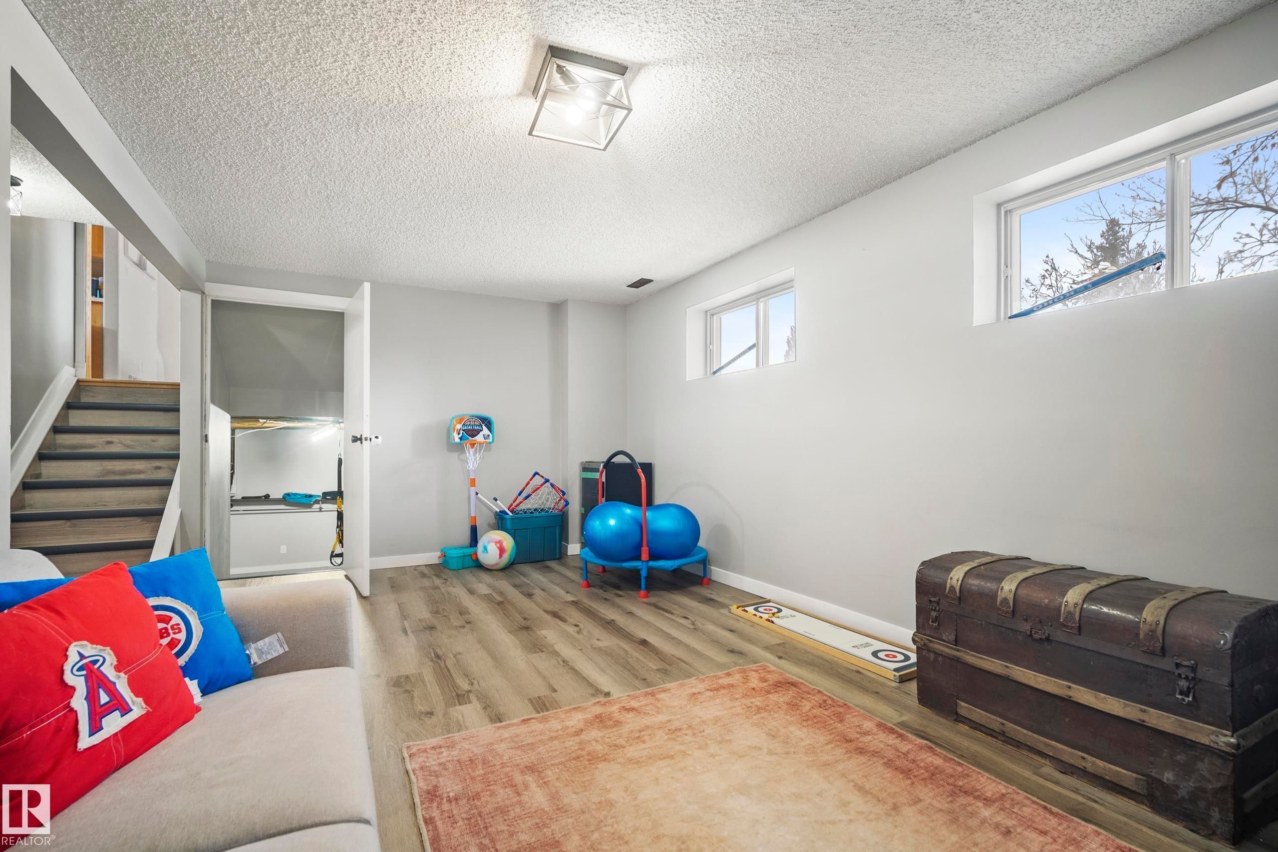 Exercise area with light wood-type flooring and a textured ceiling - 9221 84 Street, Fort Saskatchewan, AB - Indoor