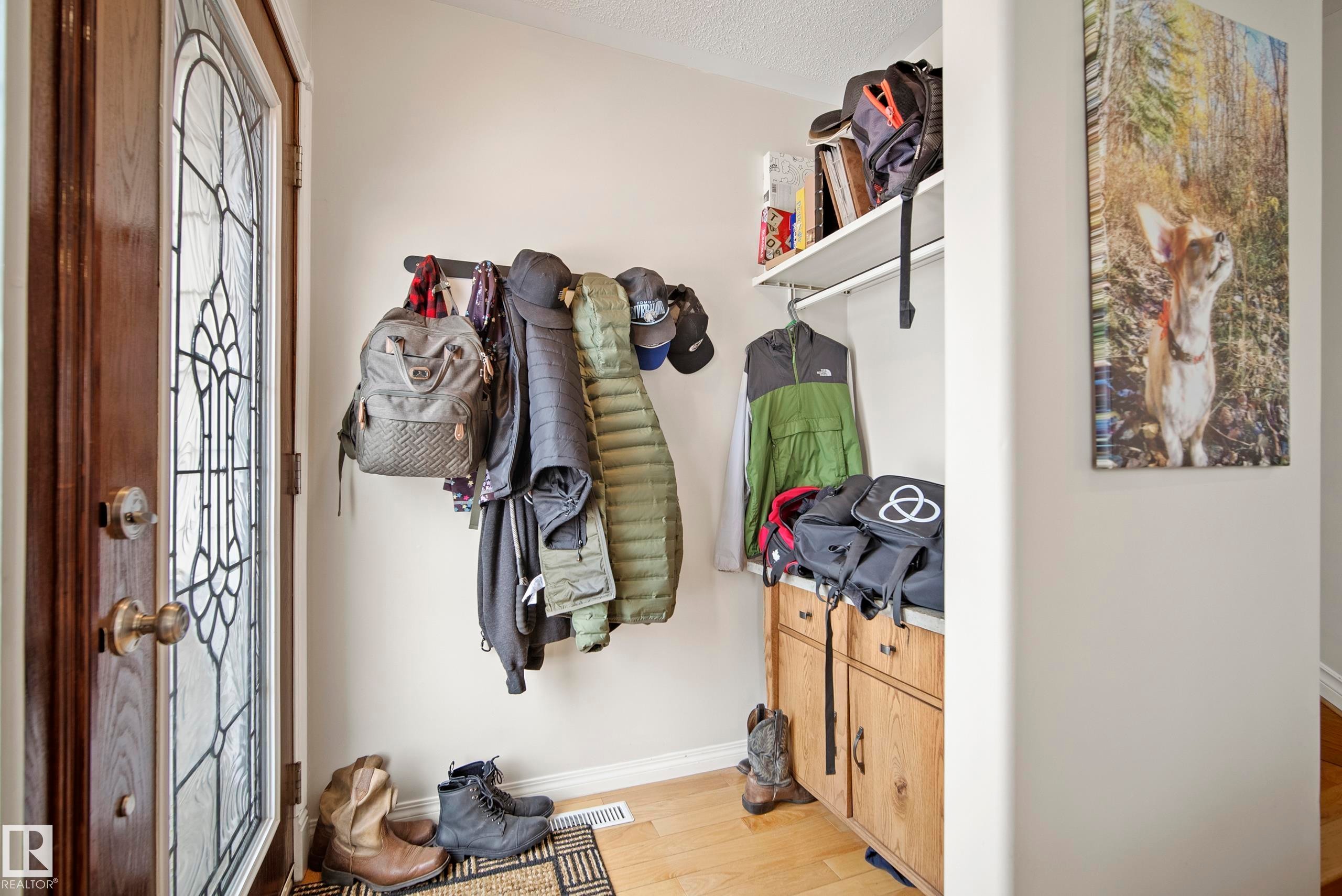 Mudroom featuring baseboards and light wood-style floors - 9221 84 Street, Fort Saskatchewan, AB - Indoor Photo Showing Other Room
