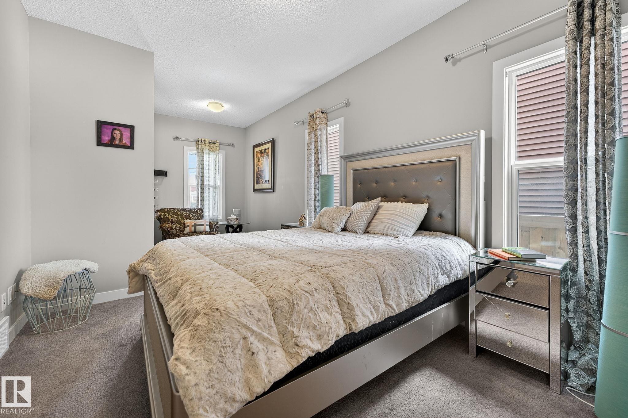 Bedroom with dark carpet and a textured ceiling - 21867 80 Avenue, Edmonton, AB - Indoor Photo Showing Bedroom