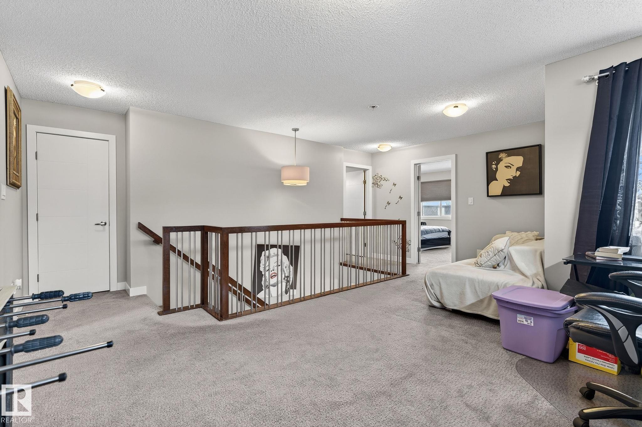 Living area with an upstairs landing, carpet flooring, and a textured ceiling - 21867 80 Avenue, Edmonton, AB - Indoor Photo Showing Other Room