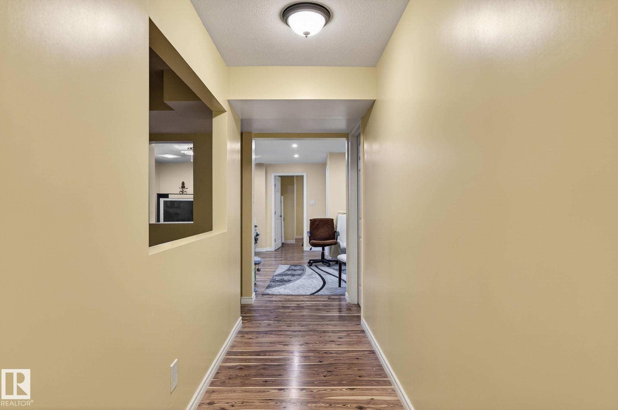 Corridor featuring baseboards and dark wood-style floors - 21867 80 Avenue, Edmonton, AB - Indoor Photo Showing Other Room