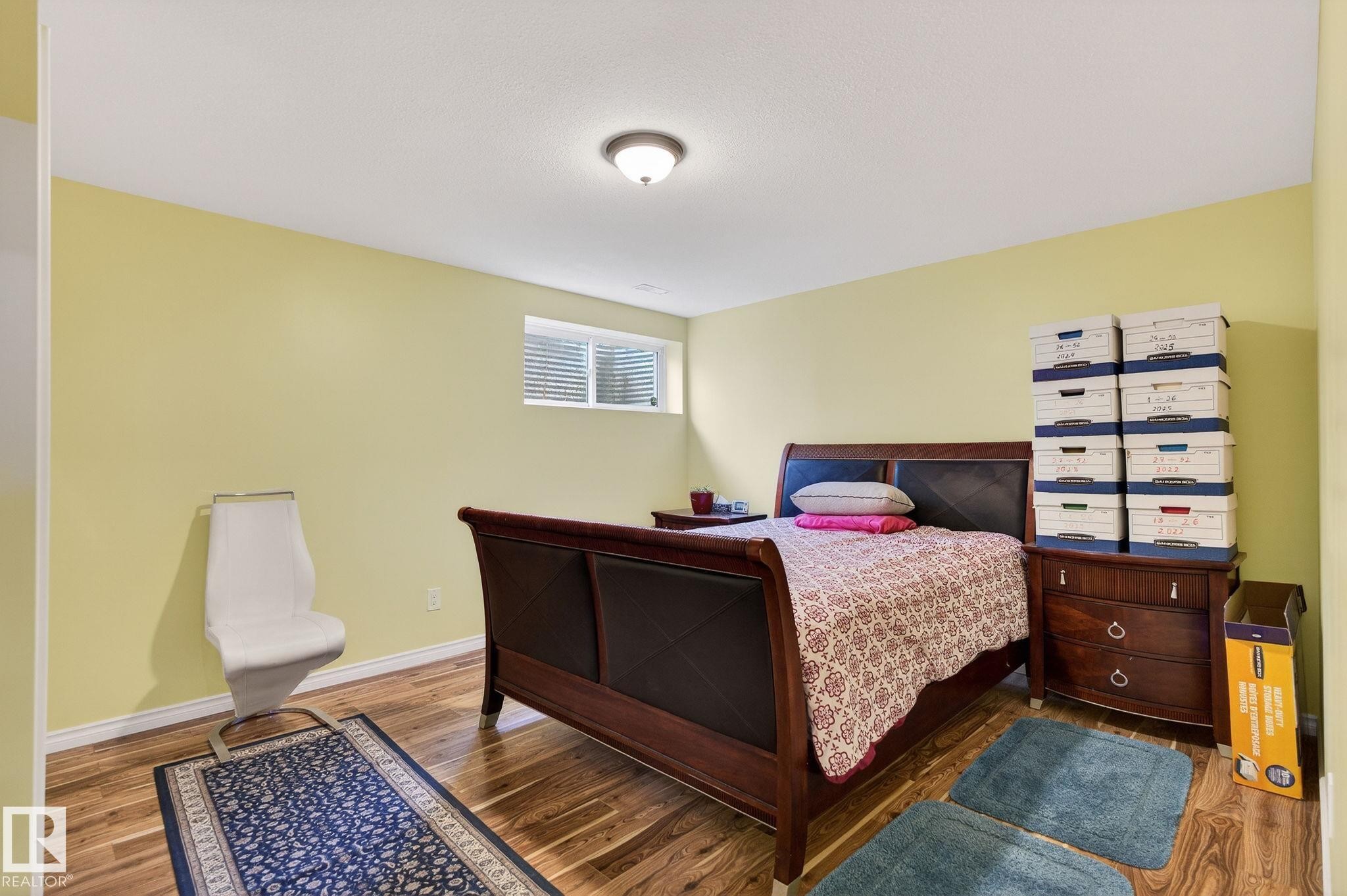 Bedroom with wood finished floors and baseboards - 21867 80 Avenue, Edmonton, AB - Indoor Photo Showing Bedroom