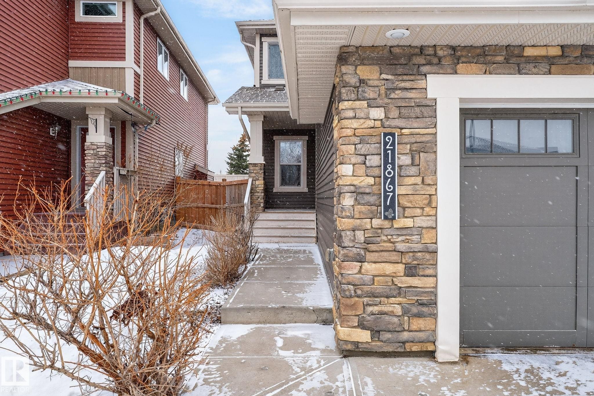 Snow covered property entrance featuring stone siding - 21867 80 Avenue, Edmonton, AB - Outdoor