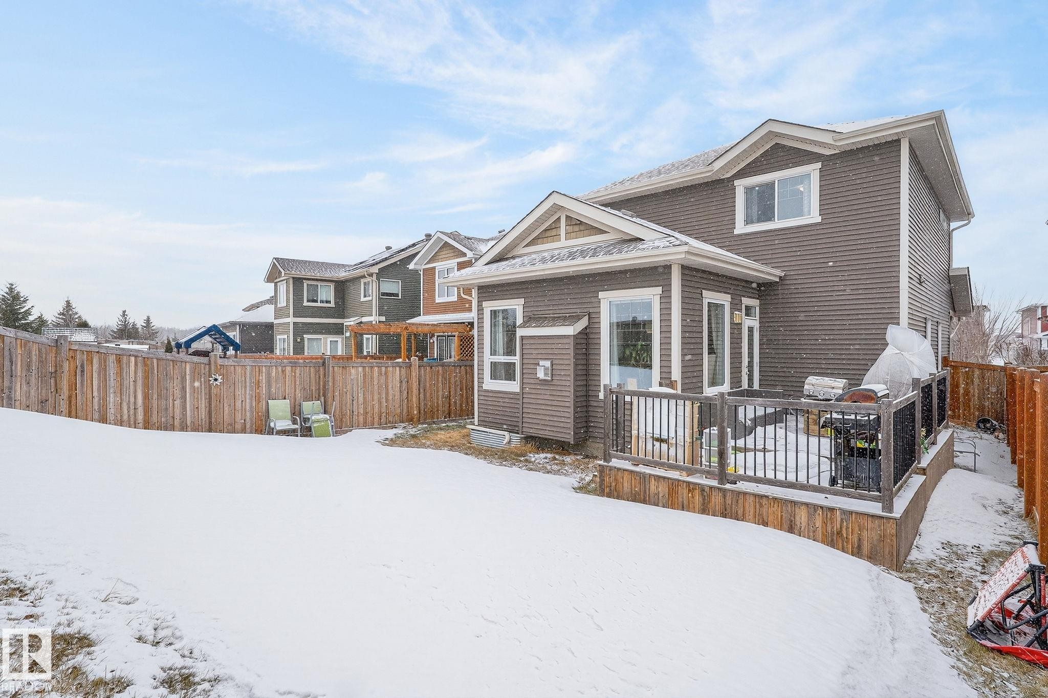 View of front of property with a wooden deck and a fenced backyard - 21867 80 Avenue, Edmonton, AB - Outdoor
