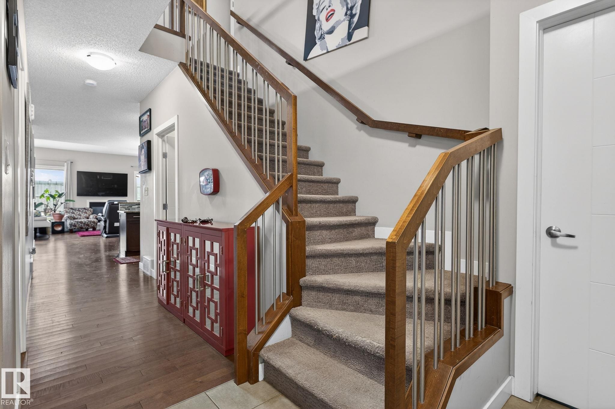 Staircase featuring a textured ceiling and wood-type flooring - 21867 80 Avenue, Edmonton, AB - Indoor Photo Showing Other Room