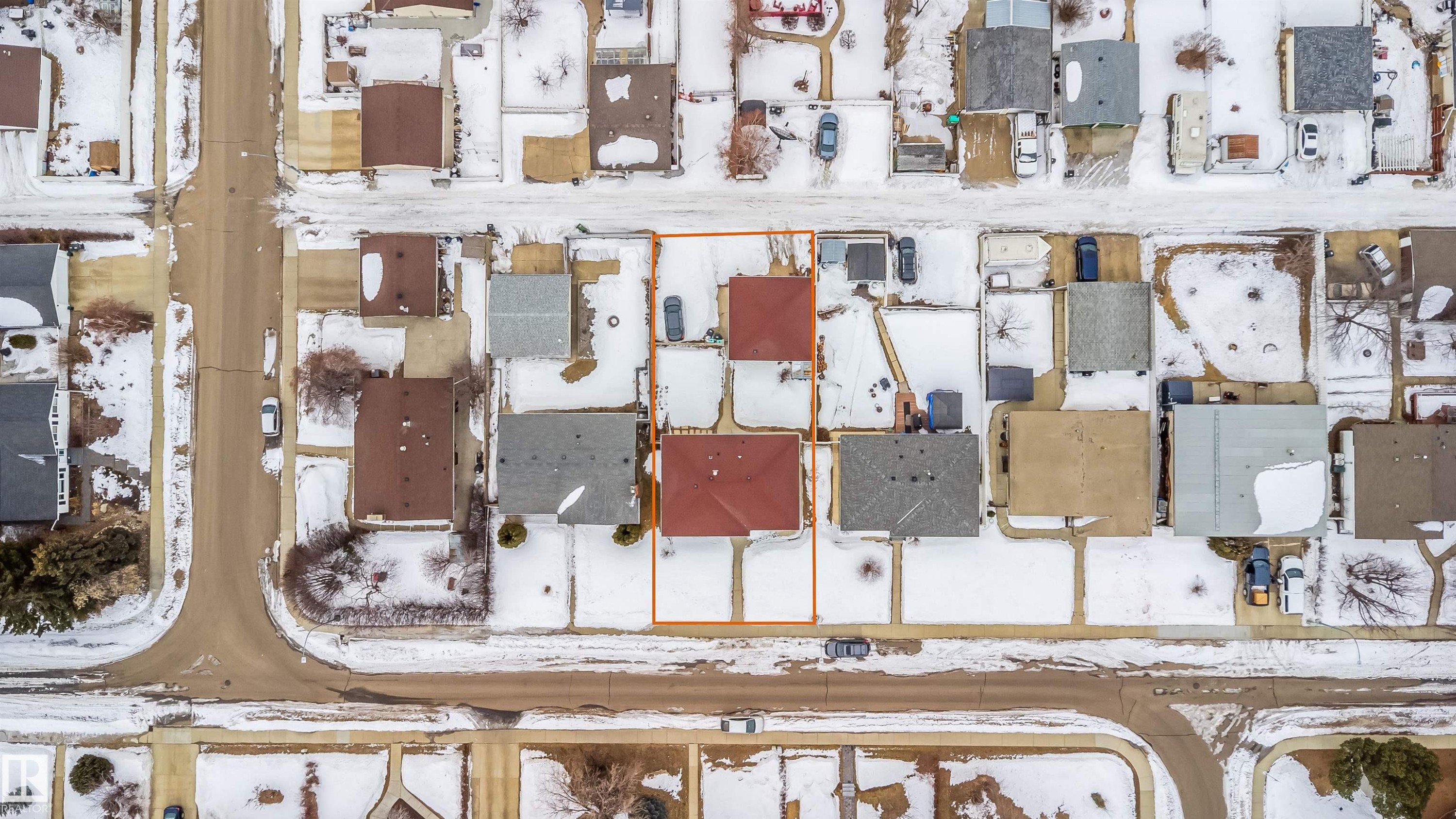Aerial view of the property, featuring a red roof and a surrounding yard - 7911 145 Avenue Nw, Edmonton, AB - Other