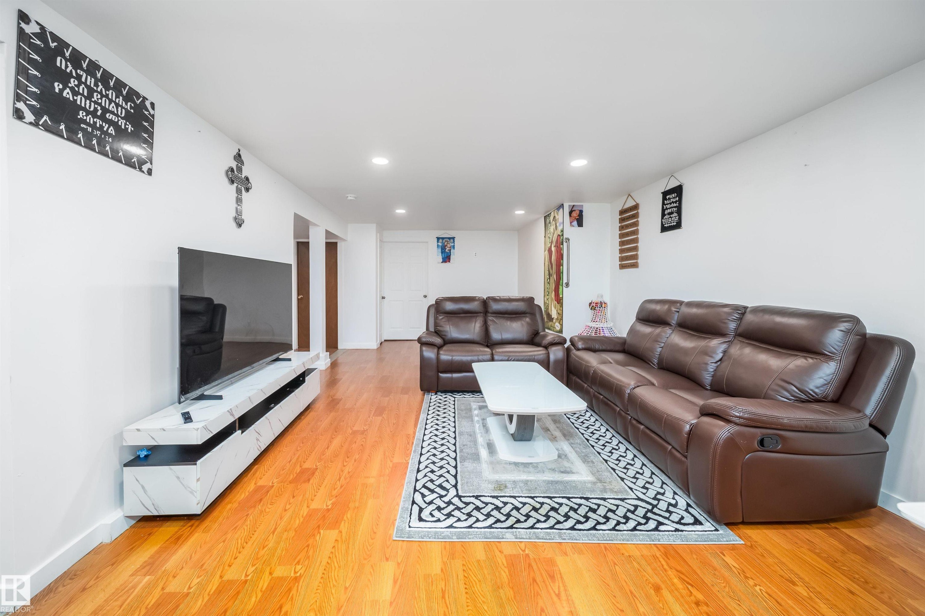 Living area featuring hardwood floors and recessed lighting - 7911 145 Avenue Nw, Edmonton, AB - Indoor Photo Showing Living Room